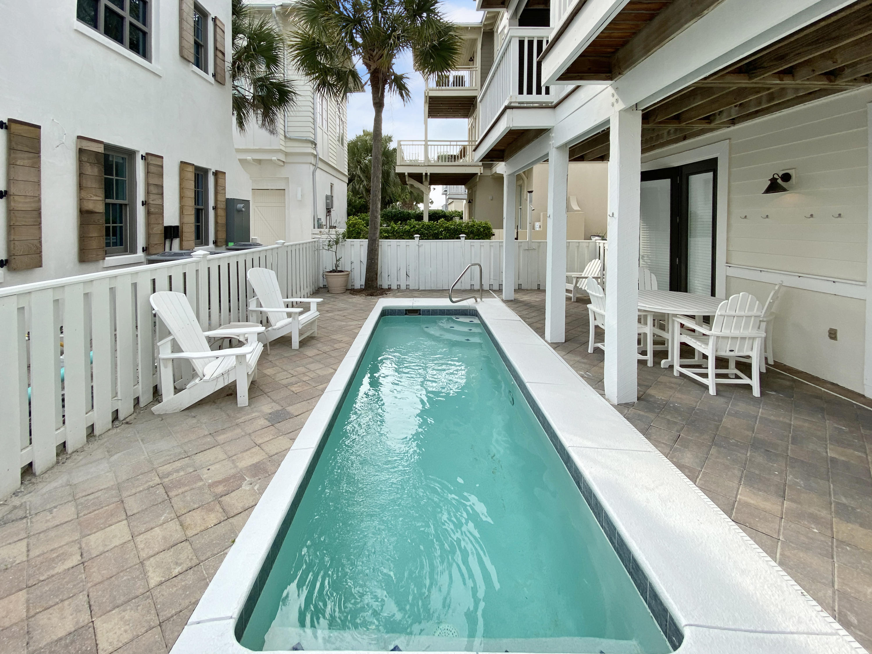 Beautiful pool home just one house from the beach in Water's Edge! The gorgeous emerald waters and white sand is just steps from the home's private pool. The second level of the homes features a spacious open plan with a recently remodeled kitchen and covered porches with gulf views. Off the living area is the first of two master suites that feature renovated baths. The second master suite occupies the top level of the home and has a private porch overlooking the pool and has views of the gulf. Two more guest bedrooms, bath, laundry, and a 2-car garage are on the first level. The lovely pool and patio can be accessed from both of the guest bedrooms. The proximity to the beach, private pool, and location all make this a great vacation rental or a wonderful family retreat.