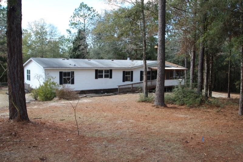 This is a WOW property. 2 beautiful wooded acres with a large manufactured home and a separate garage workshop and yard building with a covered area to store equipment. 3 bedrooms, 2 full baths, big living room divided by fireplace on both sides, large family room, formal dining plus breakfast room, indoor laundry room, and a handy in home office or hobby room. Separate garage/workshop and another building with an attached carport or storing whatever equipment you want. Home has tile and hardwood floors. Unique kitchen. Tongue and groove wood ceilings. Nice covered back porch. Very private on a cul-de-sac. Quiet, wooded, and a great house and outbuildings!!! Perfect home or getaway!!This property is eligible under the Freddie Mac First Look Initiative through 8/9//2015. This means