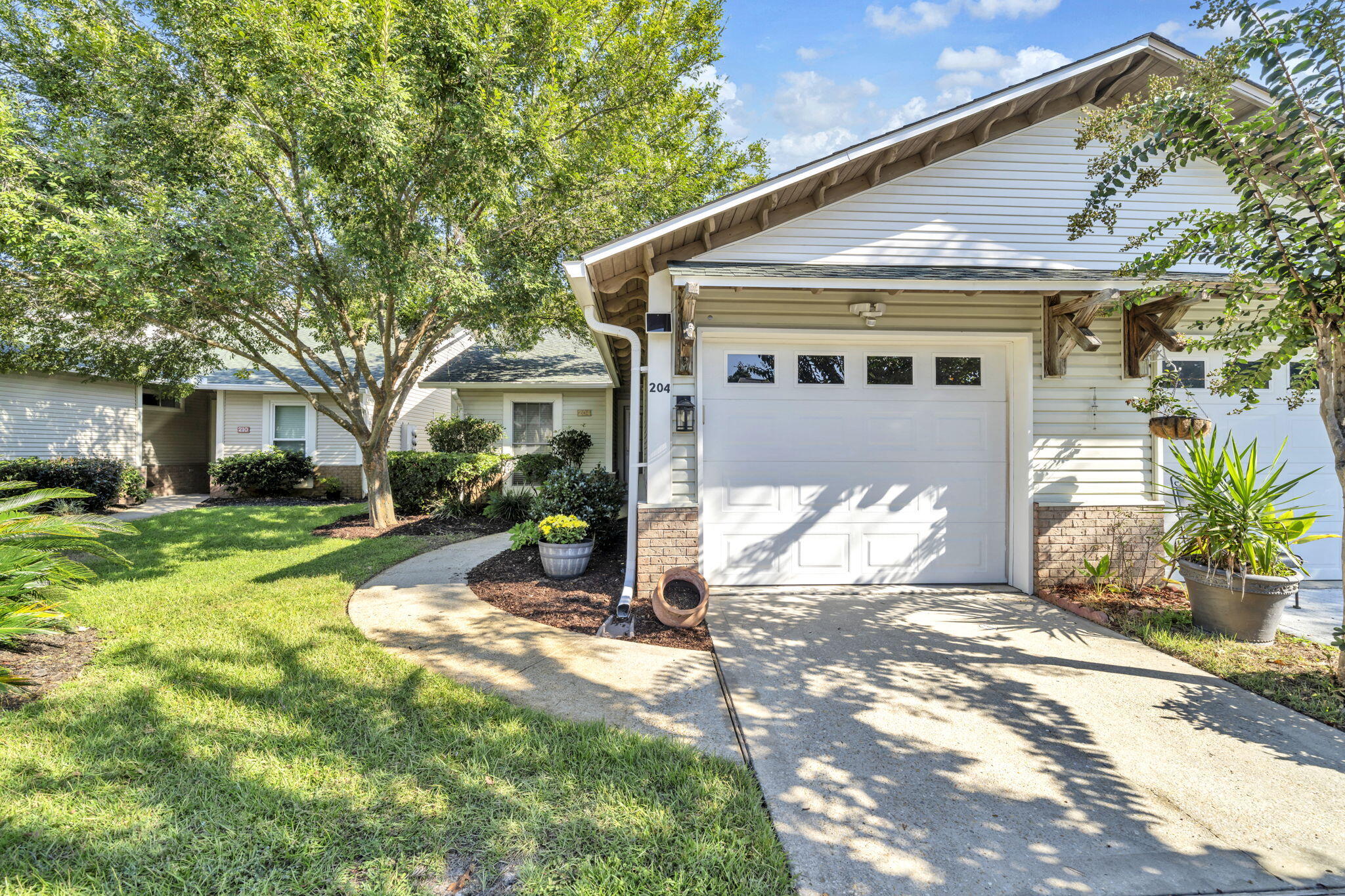 Welcome to 204 Via Largo, a beautifully maintained single-level home offering 3 bedrooms and 2 bathrooms in the desirable Escada neighborhood of Santa Rosa Beach. Inside, the open layout creates an easy flow between the living, dining, and kitchen spaces. Natural light pours in through large windows and doors, highlighting the thoughtful details, including granite countertops and a built-in mini bar that make the kitchen ideal for everyday living or entertaining. The primary suite provides a spacious retreat with its ensuite bath and walk-in closet, while two additional bedrooms and a full bath complete the floor plan.Step outside to a covered patio overlooking a private backyard--perfect for relaxing or enjoying outdoor gatherings. The Escada community HOA enhances the lifestyle with a swimming pool, yard maintenance included, and direct access to a scenic trail that leads to the renowned beaches of 30A. Blending comfort, style, and coastal living, this home is a standout opportunity in a sought-after location.