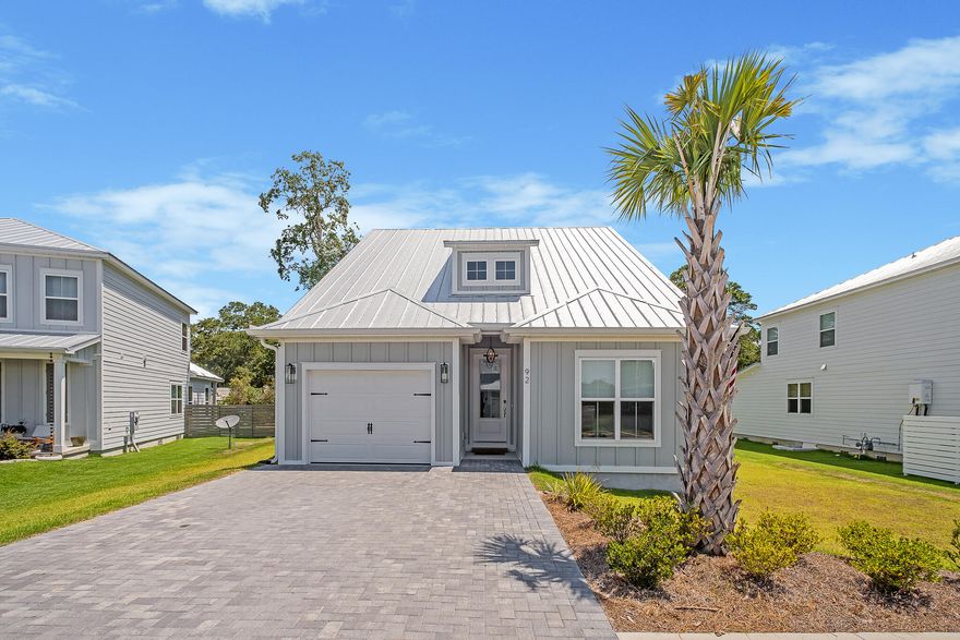 Capturing the vision of a luxurious lifestyle framed in the setting of a quiet southern town, Bayou Edge Landing is a pristine coastal cottage idyllically located on one of the largest lots in the premier community of Daxton on the Bay in the desirable Musset Bayou area of Santa Rosa Beach. Designed and offered by Truland homes in 2021, this charming Seaside A floor plan retreat was completed in early 2021 and specifically curated with unique, high-end upgrades tailored to and chosen with today's home buyers in mind. Flooded with natural light, Bayou Edge Landing is a welcoming, airy smart home with lofty nine-feet ceilings and a spacious open-concept floor plan. Luxury details include newly updated light fixtures inside and out, wood flooring, and custom blinds throughout. The gourmet