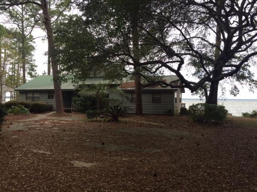 ONE OF THE LARGEST, MOST PRIVATE BAYFRONT LOTS IN SOUTH WALTON. CONVENIENTLY LOCATED AT THE END OF HEWETT PT RD. THIS PROPERTY IS LADEN W/MAGNOLIAS, HUGE OAKS, AZALEAS AND GARDENIAS. THE HOME HAS BEEN USED AS A VACATION GETAWAY AND IS IN NEED OF SOME REPAIRS/UPDATING. SURROUNDED BY WATER, THE WATERFRONT VIEWS FROM THE SCREENED BACKPORCH ARE FANTASTIC! THE WATERFRONT- OVER 400 FEET -INCLUDES BOTH BAY FRONTAGE AND CANAL FRONTAGE THAT WRAPS AROUND THE WEST SIDE OF PROPERTY. SEAWALL AND RIPRAP IS IN PLACE ALONG W/A DOCK, BOATSLIP AND BOATLIFT. THERE IS A DETACHED GARAGE AND ADJACENT CARPORT WHICH IS IDEAL FOR STORING WATERCRAFT.