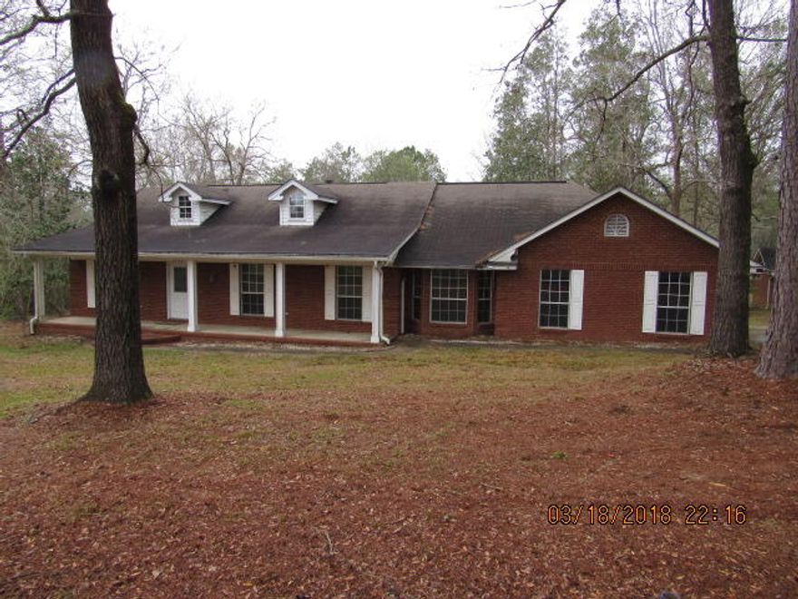 REO: If your looking for a project, look no further than this 12 acres with a home and detached garage ,centrally located between Baker and Holt. Peaceful country setting has a large Brick home with a partial unfinished basement. The 5/3 bath home has great potential. There is already a 2 car garage /workshop ready for your projects. Home is being sold as is.This home will NOT qualify for VA or FHA financing. Cash, Conventional or renovation financing only.