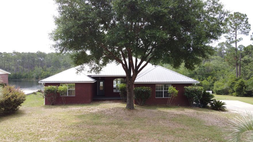 Without a doubt, one of the prettiest waterfront properties on the market! Located in Hidden Lake Estates, this gorgeous split plan brick home features 3 bedrooms (2 waterfront, to include master) 2 full baths, an office, and a half bath located in the 2 car garage. New interior paint, new laminate flooring in master, baths and office. Hand-scraped engineered hardwood flooring in living room with 9' ceilings. The expansive deck is 34' long and 10' wide and overlooks your stunning back yard and lake. Plenty of space for a pool too! Sprinkler system in front yard sourced by pump at the lake. City water & sewer. New metal roof in Dec 2018. Come see for yourself! Be sure to view the virtual tour (Matterport) for a true tour of this home!