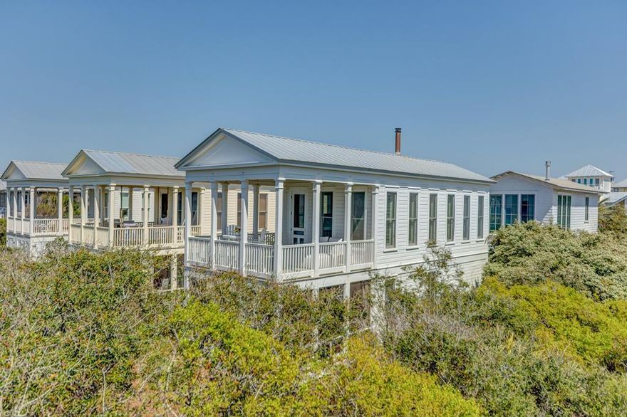 This charming Seaside property is one of the original Honeymoon cottages, nestled in a serene grove of oak trees atop the beach dunes. The first level features a welcoming foyer, bedroom, bath, and an outdoor whirlpool tub on the screened porch. The second level boasts a combined living and dining area, a kitchen, and a covered porch, both perfect for toasting memorable moments with a glass of your favorite bubbly under the moonlight. The all-wood interior is painted a crisp white and features natural finished maple floors. Relax on the second level covered porch in a hammock and enjoy breathtaking views of the beautiful emerald green water. Stay cozy on chilly winter evenings with the wood-burning stove.
