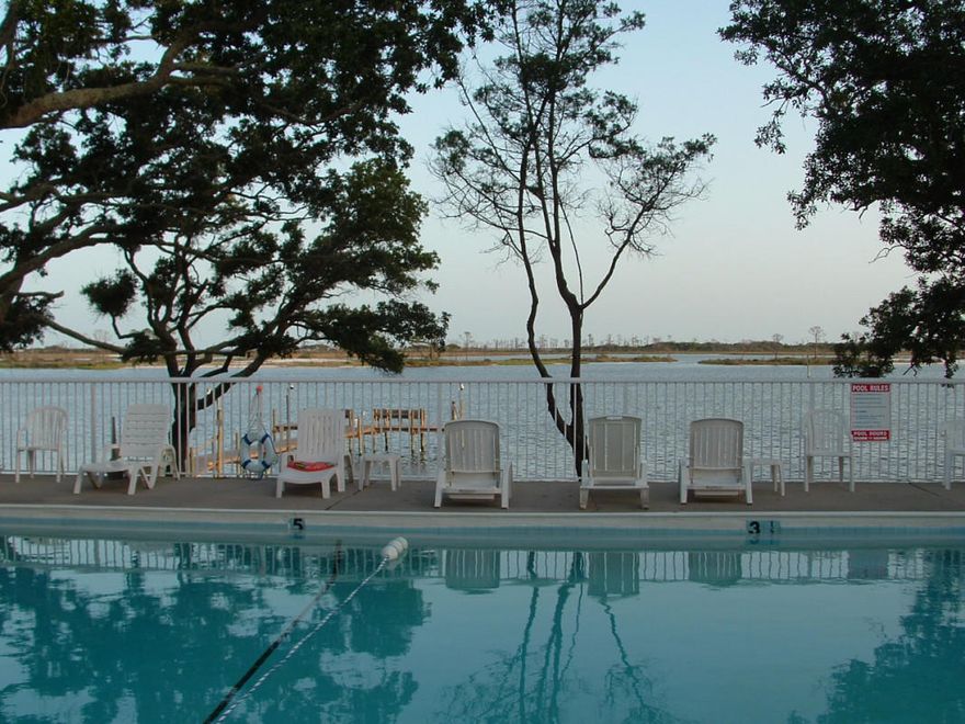 Just in time for the Holidays!! Condo complex on the Santa Rosa Sound with access to the water, beautiful view of the treed courtyard and all for a great price. This property can make for a primary home, rental property and/or vacation home. The association fee includes water, sewer, garbage, pest control, ground and swimming pool maintenance. Also included are use of clubhouse, laundry area, fishing dock, boat storage and BBQ area. Many islands dot the Sound with boat, fish, ski and camp-out areas. The complex is located conveniently to schools, military bases and shopping.