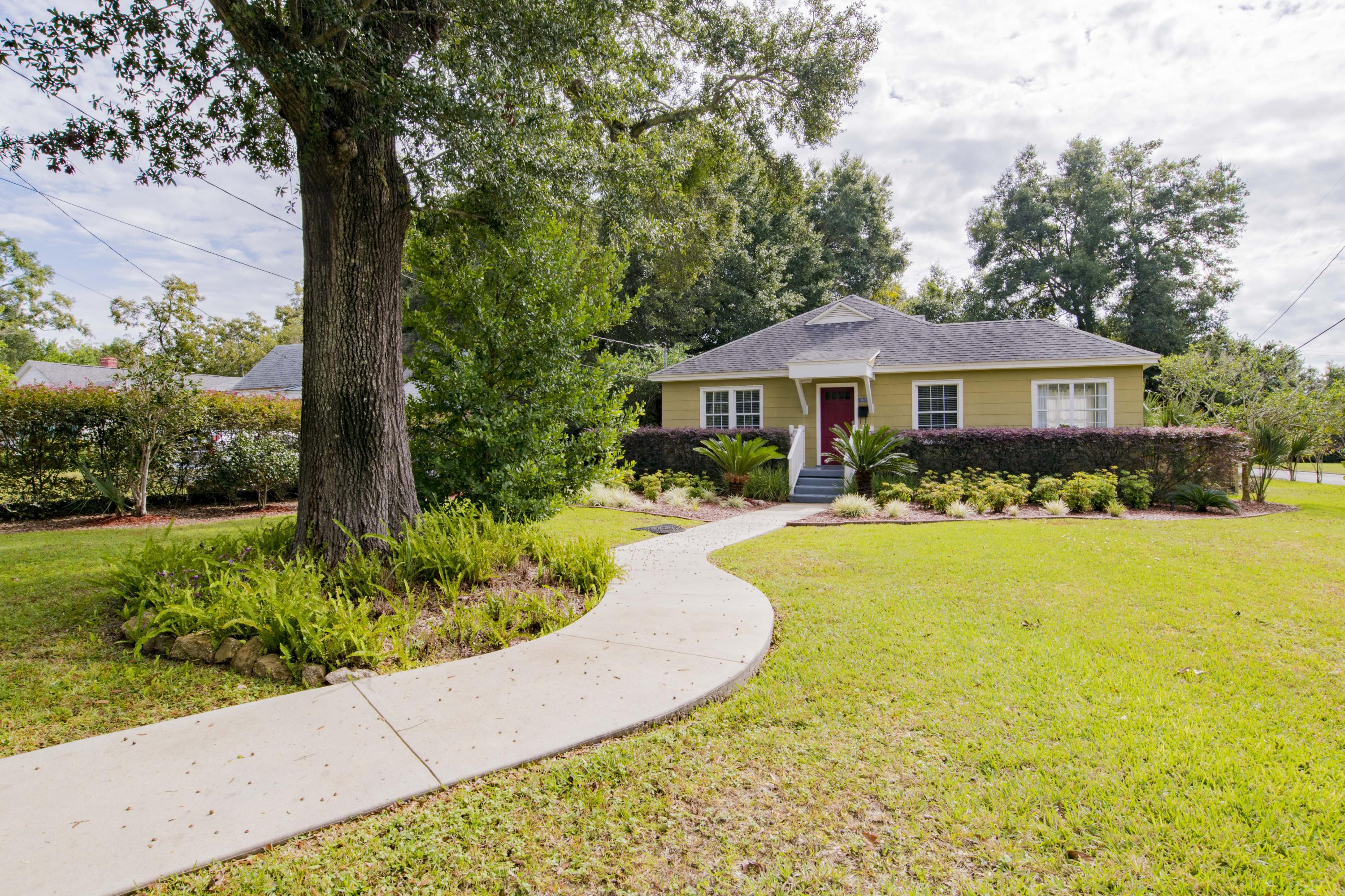 Located in the desirable neighborhood of East Hill, this charming cottage has 3 bedrooms and 2 bathrooms. Upon arrival, you'll take note of the beautifully landscaped yard, towering oak tree, and the yard perfectly lined with flowering Crate Myrtles situated on a large corner lot. This home boasts of gorgeous origional hardwood floors throughout the home, a spacious gally kitchen and a wonderful sun room flooded with ample natural light! Full of character, this impeccably mainatined 1941 home and has a detached 1 car garage with additaional storage shelving as well as a yard building. Enjoy the new East Hill Publix just 1.5 miles away, 3.4 miles from the airport and 3 miles to downtown
