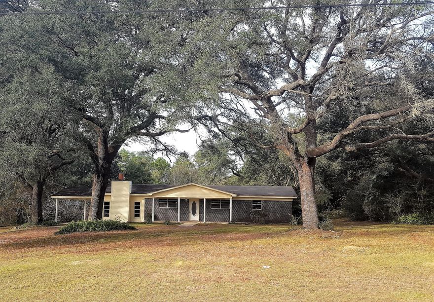 Remodeled! New Kitchen Cabinets, New Vanities, Wood looking floors through out, New Fans, Lighting, Painting and MORE! Nestled beneath huge oak trees, relax and sit on your front porch rocking your cares away. Or cozy up to your Fireplace and celebrate Christmas around the hearth. 4 Bedrooms and 3 baths or use the 4th room as your office/study. All Brick home with some vinyl siding. Property sits way off road in the midst of old oaks.