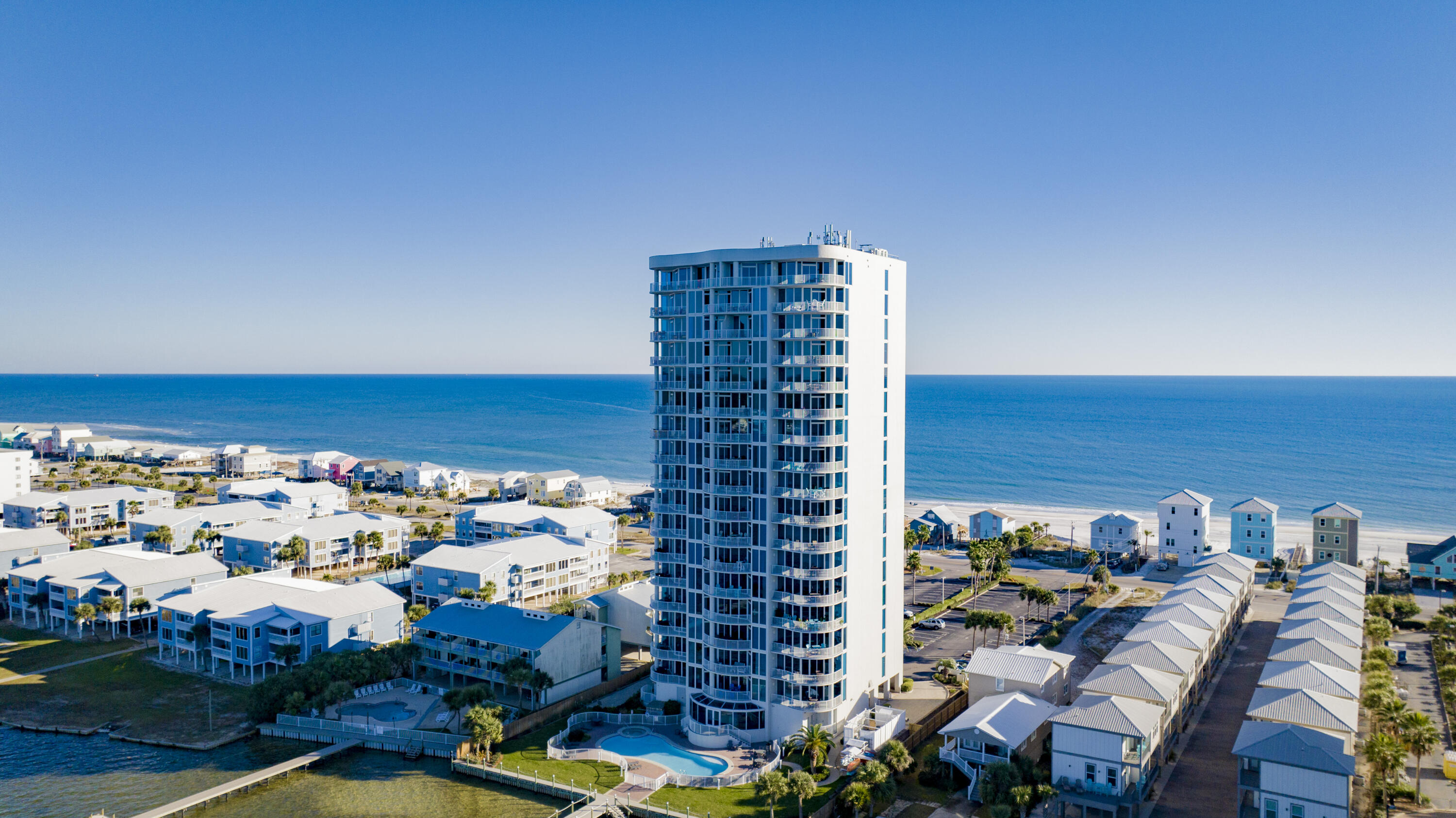 This remarkable 3-bedroom, 3-bath corner condo steals the show, boasting breathtaking vistas that defy imagination. Fully furnished with charming coastal accents and enriched with upgrades, it harmonizes coastal living with luxury. Here, anglers & beach enthusiast unite--the proximity to Little Lagoon and the sparkling emerald beach waters is unparalleled. Enter and follow the tiled path that winds through this abode, absorbing the serene beach ambiance. With only three units per floor and coded elevator access, discover a haven far from crowds, brimming with tranquility. The unobstructed panoramas of The Gulf of Mexico and Little Lagoon are priceless treasures. Gaze upon the water vistas while crafting your culinary meals in the well-equipped kitchen adorned with exquisite cabinetry, gran