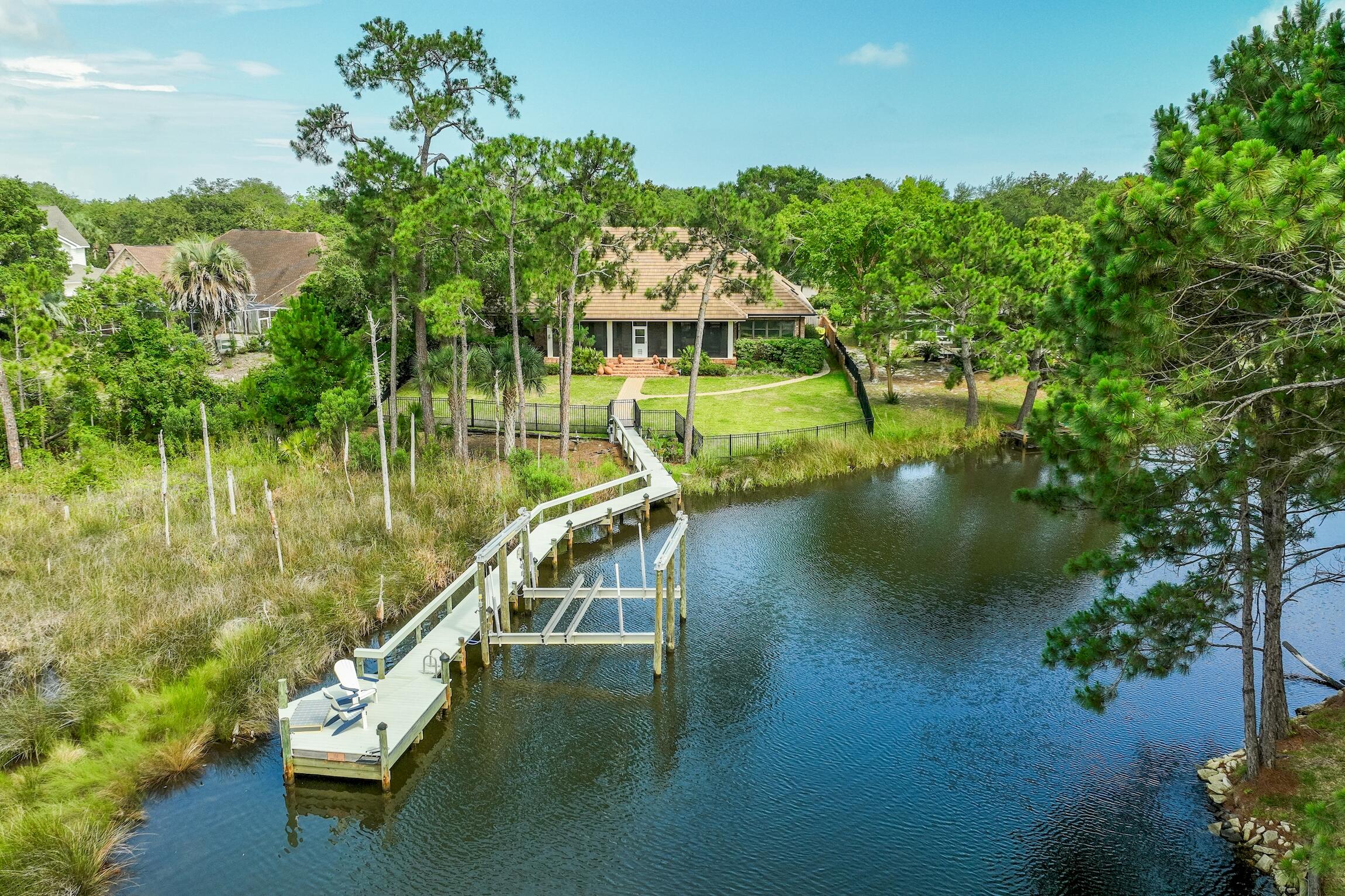 Welcome to your deep water oasis on Indian Bayou! This exquisite 4-bedroom, 3 and a half bathroom home has recently undergone extensive improvements, ensuring a luxurious and well maintained living experience. Starting with the exterior, the property boasts a brand-new concrete tile roof, complete with new gutters and skylights. The AC has been replaced throughout the home, including the addition of a dedicated A/C unit in the garage storage room. No more worrying about power outages thanks to the new 27KW Generac generator, ensuring uninterrupted comfort and convenience. Inside, you'll discover a host of impressive enhancements that include a newly renovated Kitchen and Master Bedroom Suite.