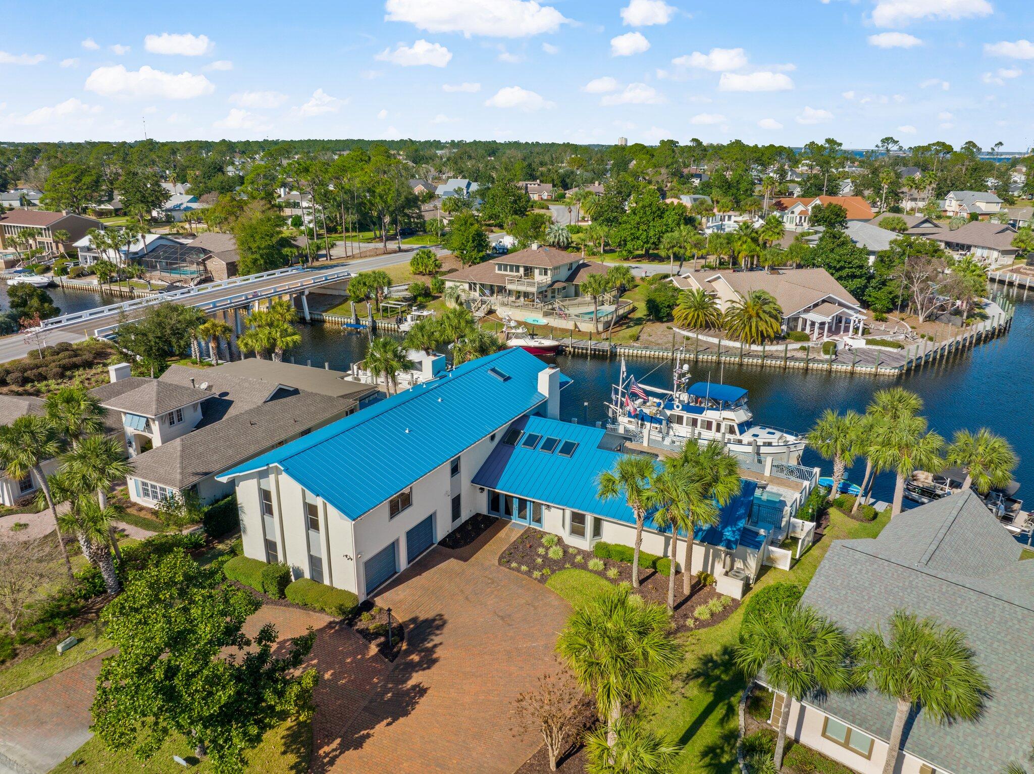 CURRENTLY UNDER CONTRACT, SELLER ACCEPTING BACKUP OFFERS. With 115 feet on the east side of the bridge, this Bay Point canal-front home is available for a new owner and new boat. Having weathered the storm, this residence with 6 bedrooms has received hundreds of thousands of dollars in enhancements including: CAT 7 Ethernet connections, Alexa enabled features, Bluetooth enabled speakers, a resurfaced 20,000-gallon pool and new paver pool deck, and a new metal roof. Schedule your visit by land or boat to see for yourself why 547 Wahoo Road offers a filling escape and waterfront fortune.