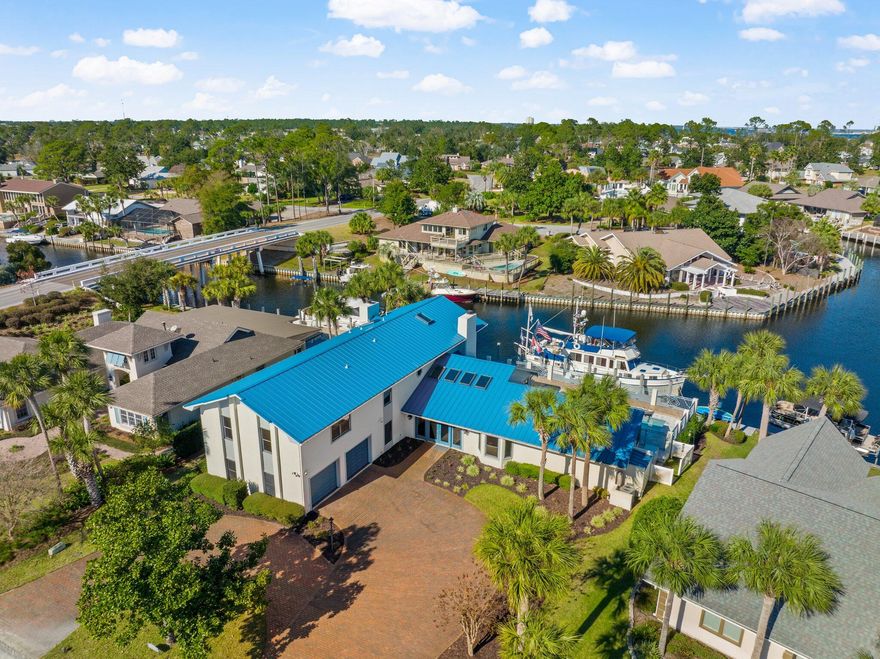 CURRENTLY UNDER CONTRACT, SELLER ACCEPTING BACKUP OFFERS. With 115 feet on the east side of the bridge, this Bay Point canal-front home is available for a new owner and new boat. Having weathered the storm, this residence with 6 bedrooms has received hundreds of thousands of dollars in enhancements including: CAT 7 Ethernet connections, Alexa enabled features, Bluetooth enabled speakers, a resurfaced 20,000-gallon pool and new paver pool deck, and a new metal roof. Schedule your visit by land or boat to see for yourself why 547 Wahoo Road offers a filling escape and waterfront fortune.