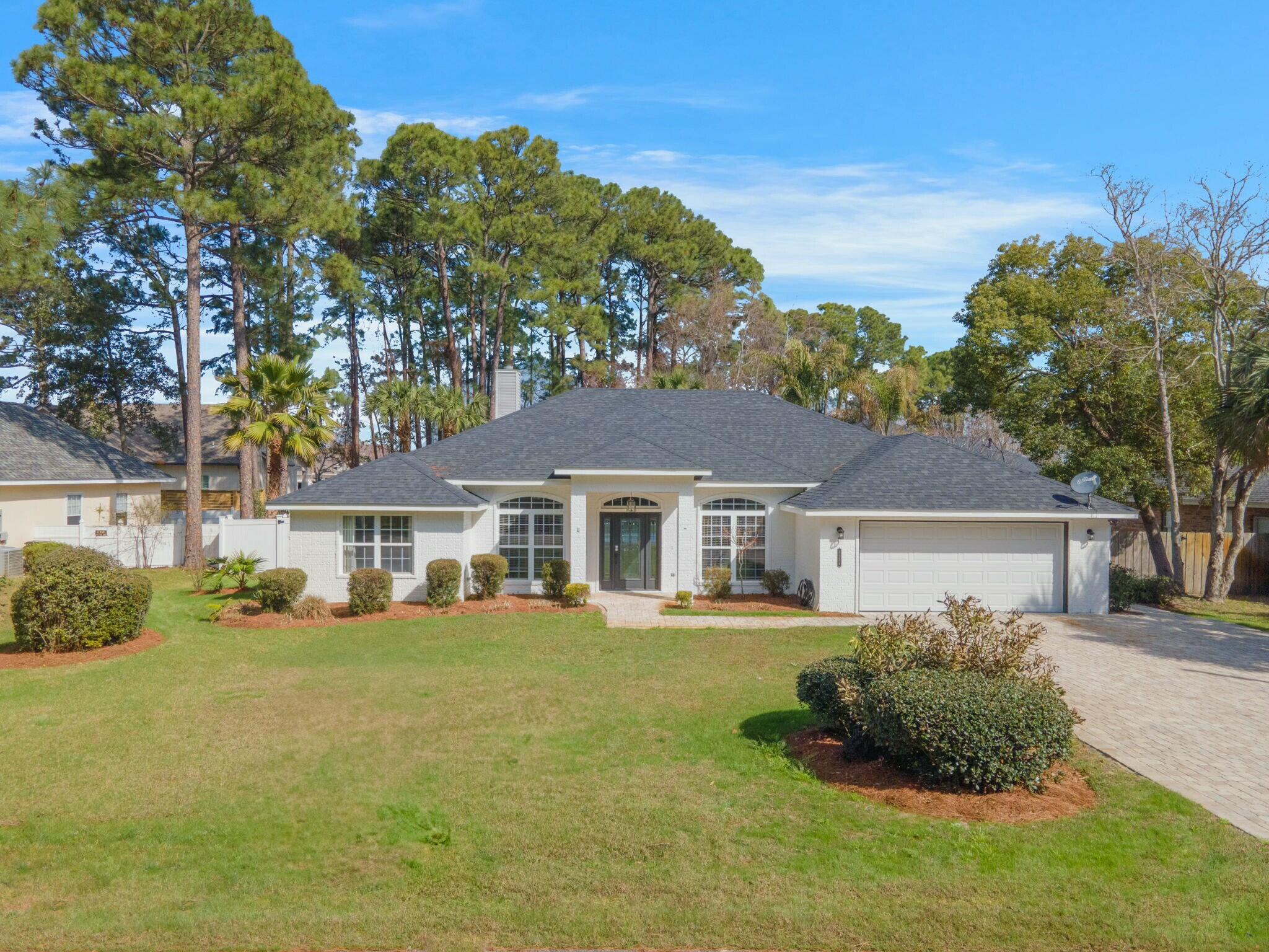 Located just minutes from everything in the Miramar/Destin area, this stunning 4-bedroom ranch-style home offers both luxury and convenience. Whether you're shopping, dining, boating, or heading to the beach, everything is within easy reach. For added convenience, a golf cart is included, capable of transporting six passengers to multiple beach accesses on Scenic 98.The home features four dedicated bedrooms and three full baths, along with a bonus room that can serve as an office or a fifth bedroom, providing flexible options. A formal dining room, gourmet kitchen with a separate eat-in bar, spacious laundry room, and a two-car garage add to the uniqueness of this single-floor home. The spacious master bedroom offers views of the outdoor oasis and includes a a recently updated master bathroom with dual vanities. Hardwood and tile flooring, along with crown molding, trayed ceilings, and arched doorways, create an upscale, high-crafted feel upon entering the home.
The home's curb appeal is enhanced by its white brick exterior with dark gray accents, a new roof, and a brick-paved driveway. A white vinyl-sided fence surrounds the property, adding both privacy and elegance. The generous outdoor space features a lanai that encloses a heated pool, adjoining hot tub, and covered patio, creating an outdoor paradise perfect for relaxation and entertaining large groups. Additionally, there's ample room for boat storage in the driveway, with a convenient launch located just 2 miles away at Legion Park.
With no HOA restrictions, this home presents a great investment opportunity for short-term rentals, boasting an established book of vacation rentals with the potential to yield $94,000 annually. Featuring nearly $100,000 worth of furnishings, updates, and added inclusions, this property is a must-see!