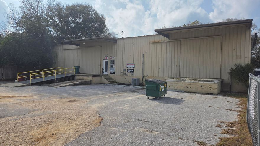 Has showroom area and couple of offices, 1 restroom. Front and Rear fenced. Above ground loading dock building with 2 rolling garage doors. 1 lot off Racetrack Rd. and next to new Circle-K.  Close to Fort Walton Beach Hospital.