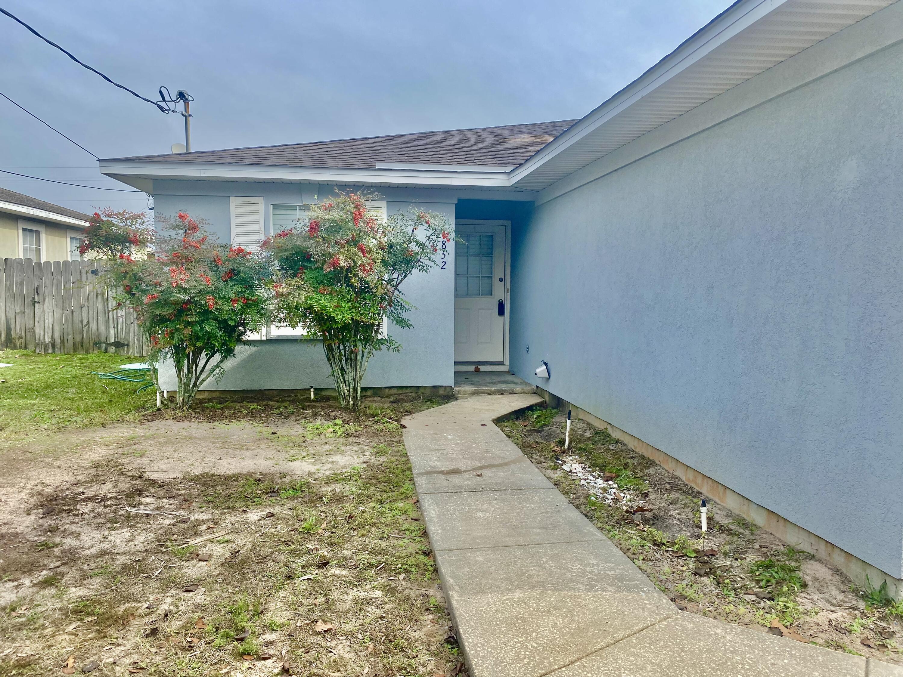 BACK ON THE MARKET...FINANCING ISSUESPerfectly located 3 bedroom 2 bath duplex (left side). Great starter home or investment property, just minutes from Navarre Beach and no HOA fees. Home is not in a flood zone.A lovely foyer helps welcome you home. Walk into the open concept kitchen with a skylight and plenty of storage, cabinets and a full size pantry. The living room/dining combo & master br.has new LVP FLOORS! Newer wash and dryer convey. LR has sliding doors to the enclosed sun room. fenced backyard. Close to shopping and public beaches. No rental restrictions or pet restrictions. Split bedroom plan! Where can you live 1/2 mile to the beach for under $300,000?This is a must see! Don't miss this steal of a deal!