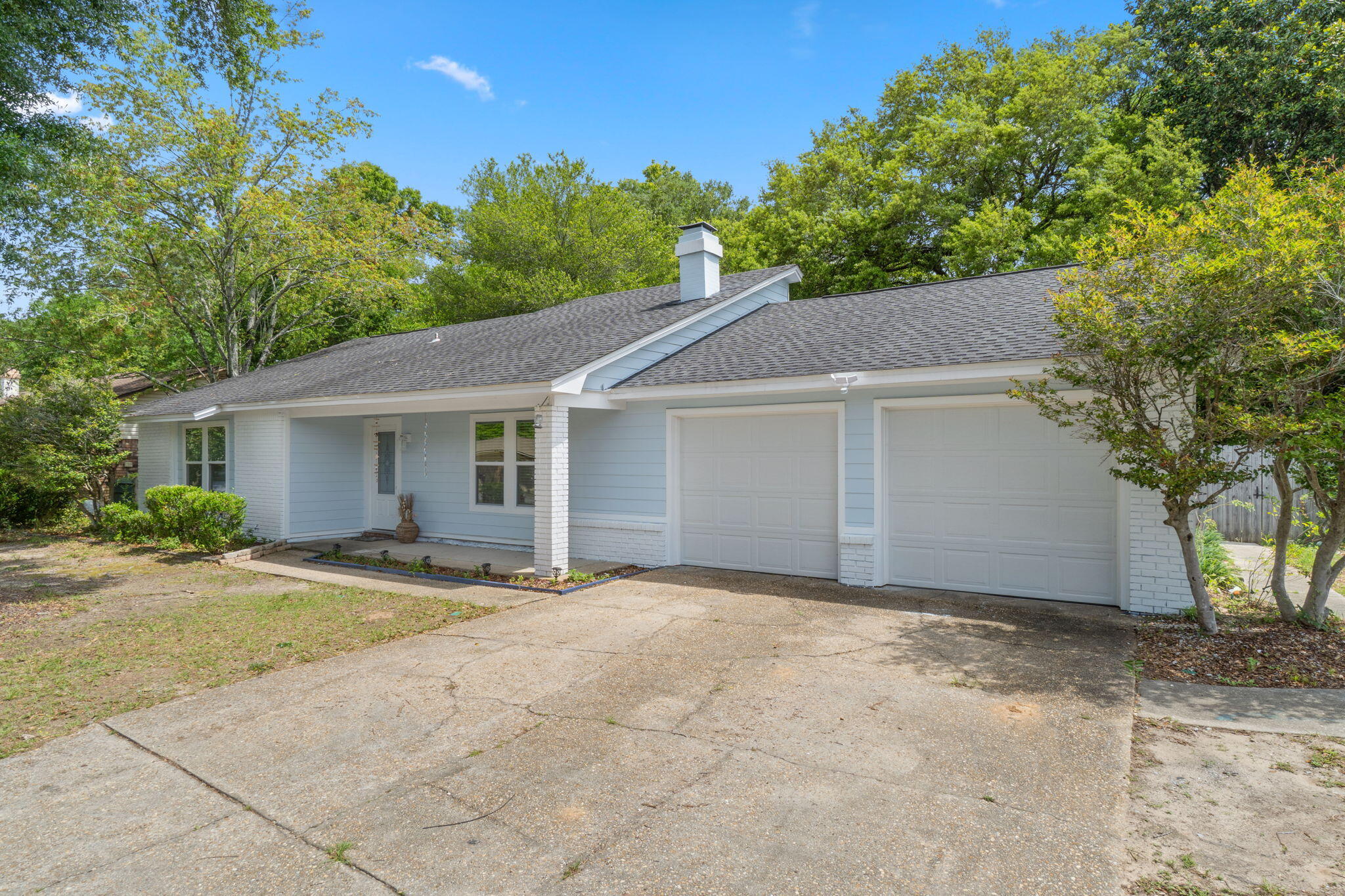 Welcome to this charming Northpointe home! Loaded with tons of recent seller updates including new exterior Hardie board siding and paint, new impact rated garage doors, new windows, new flooring, fresh interior paint, popcorn ceilings scraped and painted, and more! Situated on 0.28 acres with an expansive backyard space - All in a fantastic location to popular Pensacola points of interest and I-10 for easy commuting! The Northpointe neighborhood also features sidewalks, streetlights, and underground utilities. Stepping through the front door, you're greeted by a window accented vaulted ceiling that fills the space with natural light. The living area is accented by a cozy wood burning fireplace. Just past the living area is the dining room that seamlessly blends into the galley style kitchen with upgraded soft-close cabinets and granite countertops. This spacious home features an inside laundry room with cabinets and counters for convenience and functionality, as well as 3 bedrooms and a versatile bonus pass-through room, which can easily serve as a 4th bedroom, home office, playroom, or guest space. The oversized primary bedroom with ensuite features a newly remodeled custom vanity and a fantastic walk-in closet. All of the bedrooms feature newly installed flooring, ceiling fans, and shaker-style solid wood doors with crystal doorknobs. Schedule your showing today, and make this your Pensacola home!