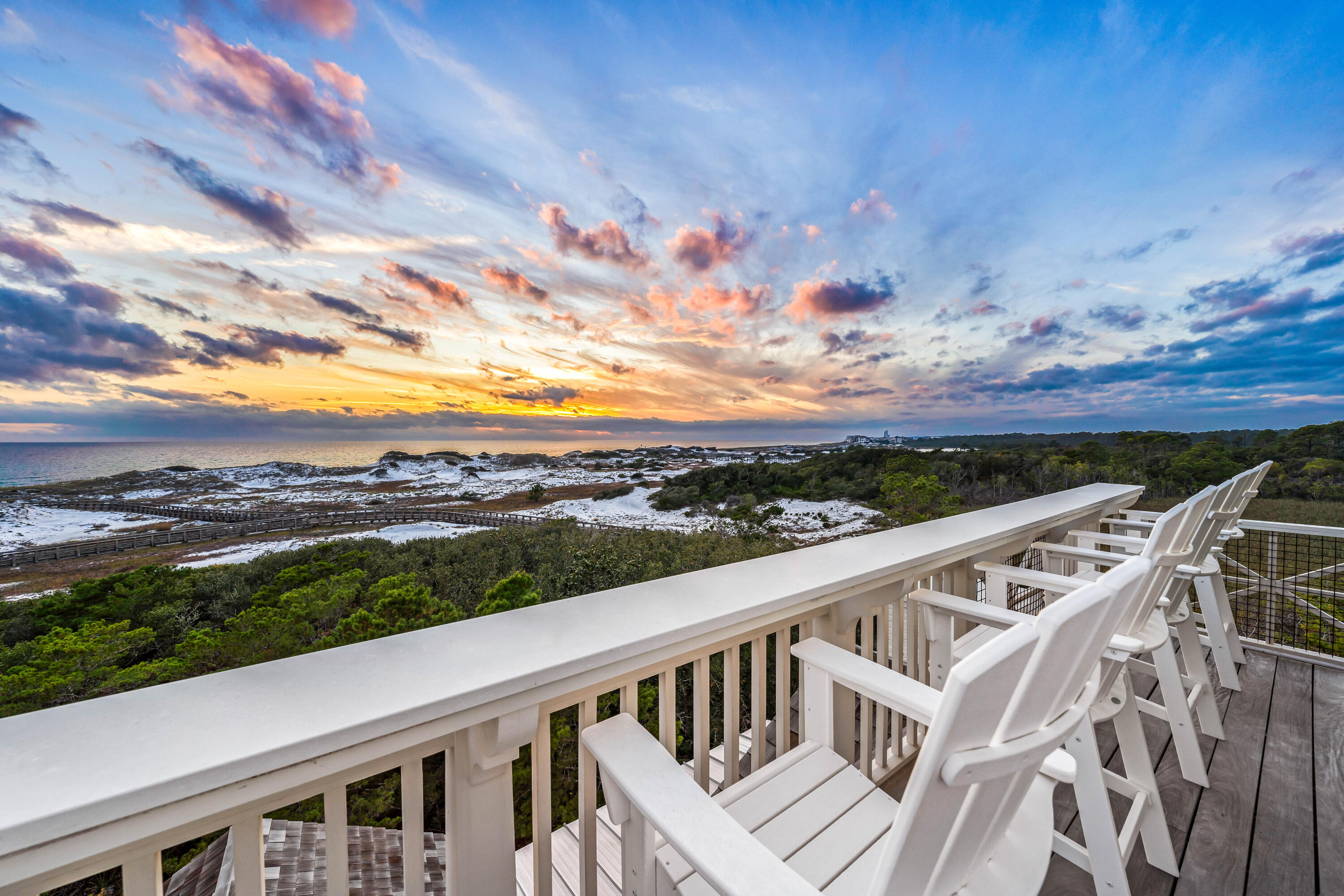 Positioned along the pristine shores of the premier WaterSound Beach community, this one-of-a-kind GULF FRONT haven presents the epitome of coastal elegance. A four-bedroom primary home and a two-bedroom guest house encompass nearly 6,200 square feet of impeccably designed interior spaces while a spacious outdoor courtyard offers a private pool, spa, and lounge area with firepit. From the moment you enter the residence, the meticulous quality of construction is apparent with luxurious finishes throughout including Venetian plaster walls, pecky cypress cabinetry and walls, custom millwork, beamed ceilings, brick accent walls, custom tiled bathrooms, hidden closets and so much more. The first level of the home offers the ultimate gathering space with a secondary living room with multiple seating areas, a gorgeous pecky cypress bar with Asko dishwasher, icemaker, and a Sub-Zero miniature refrigerator. There are also a guest suite with ensuite bathroom and a bunk room with four built-in bunks and an ensuite bathroom. Open and screened porches provide additional spaces to enjoy on the first floor.
Ascend to the second level via the custom staircase or elevator for added convenience. This grand space encompasses the primary living spaces with a gourmet kitchen, wine room, living room, dining room, and a spacious covered porch with summer kitchen and fireplace. Highlights of the kitchen include marble counters, custom cabinetry, a Cove dishwasher, Wolf gas range with hood, and Sub-Zero refrigerator and freezer while the wine room offers built-in storage, a Sub-Zero wine fridge, beverage center and icemaker. An elegant guest suite with ensuite bathroom is also located on the second floor plus a powder room. Connected to the main house via a unique glass catwalk is the sizable guest home. It includes a sitting area, two bedrooms and a full bathroom.
On the third level, find the primary suite with spectacular views across the breathtaking natural sand dunes of WaterSound Beach. A separate sitting area, pecky cypress walls, incredible ensuite which includes a television in the mirror, built-in office, morning bar with Sub-Zero wine refrigerator and icemaker, and private porch with gulf views make this a truly luxurious owner's retreat. On the top floor, find the crowned jewel with a cozy sitting area with pecky cypress walls and ceilings and exterior porch all with magnificent Gulf views.
Follow a wooden boardwalk winding through picturesque dunescape directly to the beach from this residence. Outstanding community amenities including swimming pools, a puttering park, community green space, and a state-of-the-art fitness center are steps away. This stunning gulf-front home is a masterpiece of design, seamlessly blending modern sophistication with the natural beauty that defines the 30A Gulf Coast and offers a one-of-a-kind opportunity for the most discerning buyers.