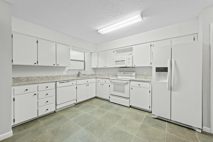 **New Roof to be installed.**  Welcome home to this recently renovated townhome. This spacious unit is centrally located close to shopping, restaurants, and our beautiful beaches. It is newly painted, has granite countertops in kitchen and baths, new stair treads, new doors, new faucet fixtures, and new fridge & microwave. New laminate flooring with tile in the wet areas. No carpet! Lots of storage, covered patio, and a nice yard with a privacy fence. The garage has been converted and can be used as an additional bedroom with private entrance or anything else you can think of. This home is move-in ready and a must see. Roof - 2013, Water heater - 2017, HVAC has 2 units. Schedule a showing today.