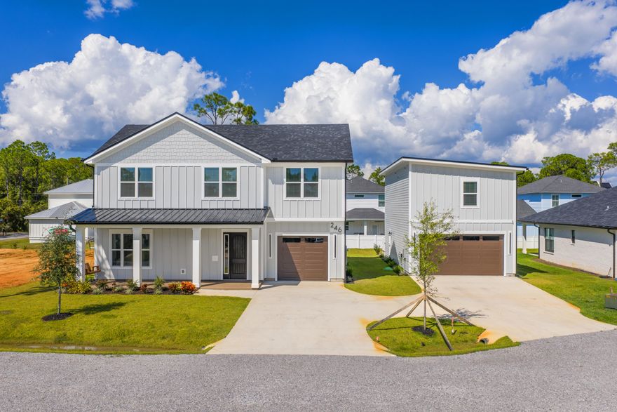Brand-new coastal home in Santa Rosa Beach with 5 bedrooms plus a detached carriage house. The main residence 2,585 sqft features a primary master suite on the first floor, three bedrooms upstairs, and a versatile studio/flex bedroom. An open staircase with a stunning chandelier cascading to the second floor creates a dramatic focal point. The designer kitchen offers quartz counters, farmhouse sink, custom hood, double ovens, and stainless appliances. Wide-plank flooring, high ceilings, and black/gold accents highlight the finishes. The carriage house 800 sqft includes 2 bedroom, 1 bath, kitchen, laundry, and private entry above an 800 sqft. garage -- ideal for family, guests, or rental income. The site plan allows for a pool in the backyard, enhancing its appeal for full-time living.
