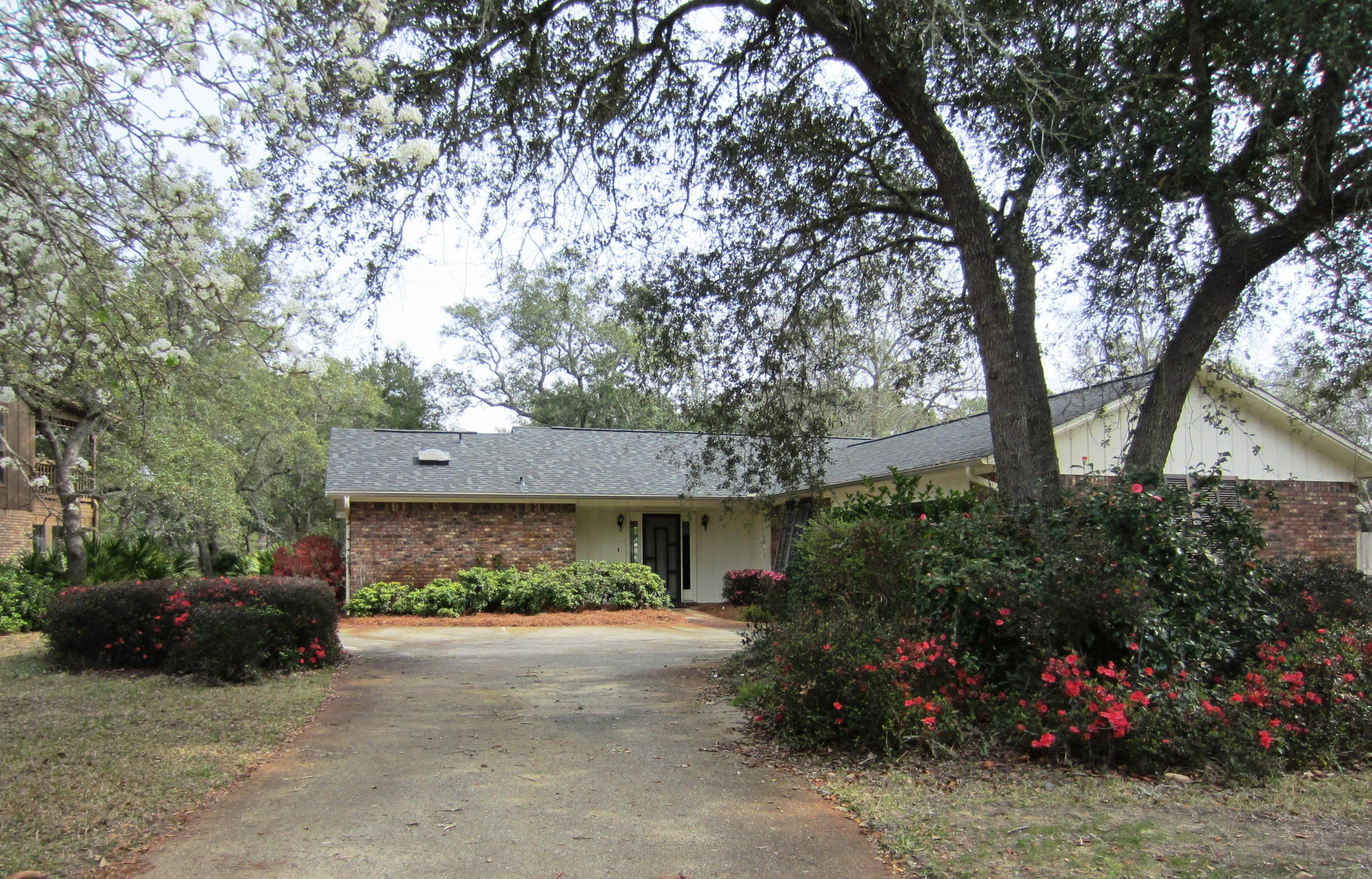 IMMACULATE! Beautifully maintained 3 bedroom, 2 bath all brick home in a great neighborhood! This split bedroom floor plan features a living/dining area with wood burning fireplace, an eat-in kitchen, and a bright Florida room with wonderful views. The professionally painted garage has built-in closets with lots of storage and custom screens. The roof was replaced in 2014. The home also features Spanish cedar hurricane shutters, newer A/C system and hot water heater, and newer stainless steel refrigerator and garbage disposal. This is a wonderful neighborhood with NO HOA fees and NO flood insurance required! Definitely a must see!