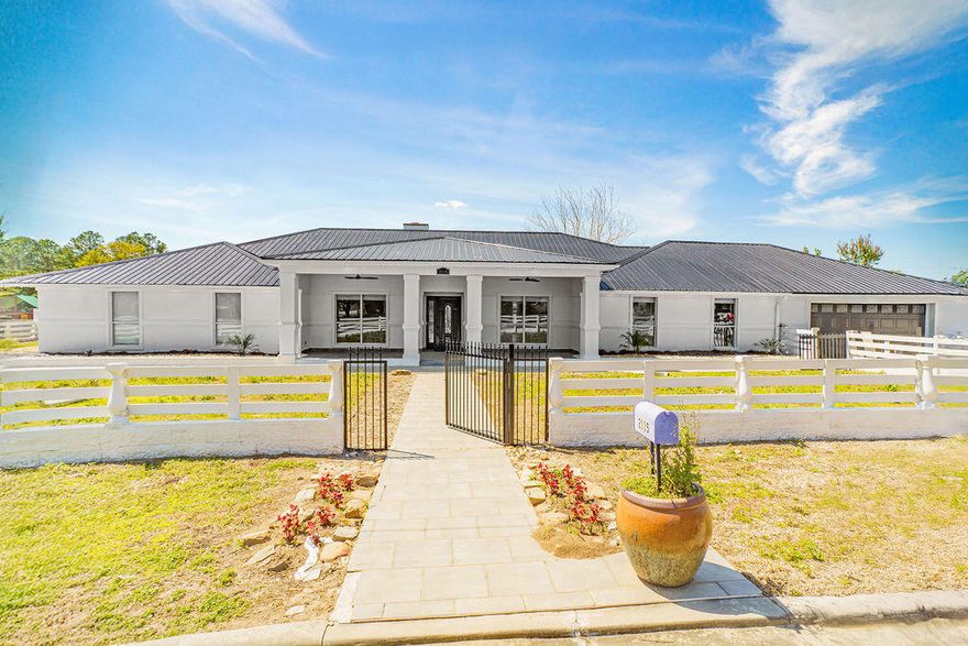 This large home is within 1/2 miles from Tate High School. Home has 3929 SF with a new metal roof (2025), new stucco finish (2025), split rail fencing in the front yard and Windsor wall fencing for the entire rear of the property. This home has 4 bedrooms, 3 full baths and a bonus office/slash study. There is a bonus room, that is a must see. Split bedroom home with new LVP in most of the home. New carpet was installed in the master bedroom and master closet area as well as in 2 bedrooms and a hallway. Full baths are completely tiled (including the ceilings).
