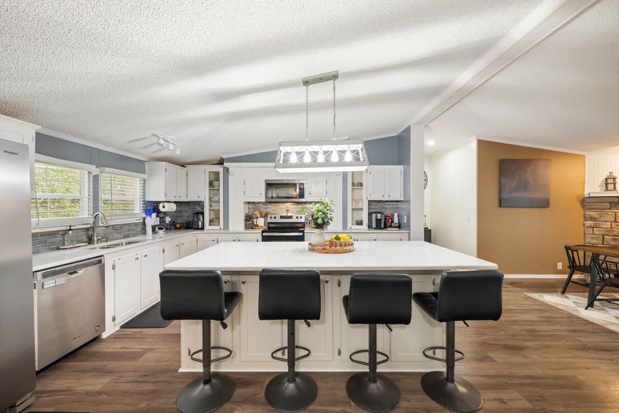 Tucked away on a quiet street with no through traffic and located just minutes from the white sands of Navarre Beach, this spacious nearly 2,400 sq. ft. home offers 4 bedrooms, 2 bathrooms, and a dedicated office--providing the space, layout, and coastal convenience buyers are looking for. Major updates include a new roof installed in 2022 and a storage shed added in 2023 for extra storage. The washer and dryer convey, and the home has been pet-free and well maintained, creating a clean, move-in-ready environment.Outdoor living is easy here. Relax on the screened porch, unwind on the porch swing, or gather with friends and family around the backyard fire pit. The fully fenced yard offers plenty of space for entertaining, gardening, or simply enjoying peaceful evenings outdoors. Inside, the spacious primary suite provides a comfortable retreat with a spa-style bathroom featuring double vanities and a soaking tub designed for relaxation. A separate office offers flexibility for working from home, hobbies, or additional living space.

The heart of the home is the open kitchen and living area, where quartz countertops, stainless steel appliances, and a large island with seating create a natural gathering space. Vaulted ceilings and luxury vinyl plank flooring add style while enhancing the bright, open feel of the home.
