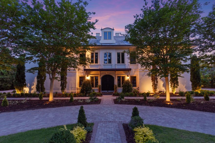 Welcome to 434 Captains Circle--an extraordinary European-inspired French Chateau, gracefully positioned within the prestigious, guard-gated enclave of Regatta Bay. This private, 24/7 secured sanctuary offers a rare blend of refined elegance and coastal serenity, meticulously crafted for both grand-scale entertaining and elevated everyday living. Set on 1.23 acres of lush, manicured grounds and constructed with ICF for enduring strength and efficiency, this custom estate is a testament to timeless design and impeccable craftsmanship. Uniquely sited right off the tranquil shores of Choctawhatchee Bay, the residence boasts over 80 feet of waterfront, framed by native sawgrass and an untouched nature preserve--offering a truly serene and picturesque backdrop. Encompassing nearly 8,000 square feet of exquisitely appointed interiors, this architectural masterpiece embodies the art of fine living, where grand proportions and classical French design converge with modern comfort. Each room has been thoughtfully curated to exude casual luxury, timeless detail, and an effortless sense of sophistication.

As you arrive at this stately estate, you're welcomed by mature, manicured landscaping and an expansive brick paver circular drive centered around an exquisite Italian fountain perfectly framing the limestone-clad fa??ade of this chateau-inspired masterpiece. Constructed with nearly 9-inch thick poured concrete exterior walls, the home offers unparalleled structural integrity and timeless grandeur. The entrance is marked by a pair of magnificent, hand-carved mahogany doors, each standing 8 feet tall, opening into a breathtaking two-story foyer crowned with a soaring 22-foot domed ceiling. A sweeping freestanding curved staircase known as the 'wedding' stair graces the space, crafted in rich wood and adorned with intricate ironwork. Italian marble columns, dual Juliette balconies, and grand architectural symmetry elevate the ambiance. Throughout the estate, natural oak hardwood floors, 10-foot ceilings, and lavish Venetian plaster walls are complemented by elaborate millwork, including 14-inch baseboards and crown moldings ranging from 8 to 14 inches each detail a testament to timeless artistry and refined craftsmanship.

Just off the grand foyer, refined functionality allows access to a tastefully appointed powder room, a private elevator, and two oversized garages accommodating up to four vehicles and/or a golf cart, complete with newly finished polyaspartic-coated floors for a sleek, durable finish. Beyond the foyer, the estate opens to expansive, light-filled living spaces framed by grand windows and elegant French doors, inviting in an abundance of natural light. The formal dining room is an entertainer's dream, currently showcasing an ornate Italian table that comfortably seats twelve beneath a custom-painted ceiling medallion and a striking Art Deco-inspired glass chandelier. The chef's kitchen is both stylish and functional, featuring refreshed custom cabinetry with sleek contemporary hardware, granite countertops and backsplash, a spacious walk-in pantry with custom shelving, a generous center island, and a separate breakfast bar. High-end appliances, including a Sub-Zero refrigerator, Thermador double ovens, Viking gas range and microwave, and more, ensure culinary perfection in every detail. Anchoring the living area is a stunning marble gas fireplace flanked by custom wood built-ins, offering warmth and timeless charm. Hidden within the home's refined design are two private studies what we fondly call its 'secrets.' One office exudes soft elegance with lighter tones, built-in bookcases, and dual French Empire crystal chandeliers, while the second office/den is richly appointed with Brazilian wood accents, intricate custom shelving, dramatic 10-foot Italian marble columns, wood-paneled walls, and wood-coffered ceilings evoking the grandeur of a European gentleman's library.

Occupying the second floor, the opulent primary suite offers a private sanctuary of sophistication and comfort. A serene balcony overlooks the pool area, while a marble-clad gas fireplace adds warmth and timeless elegance. Rare and indulgent, the suite boasts dual spa-inspired ensuites, each with its own distinct design narrative. One bath evokes a coastal serenity with soft hues of cream and blue, featuring a freestanding tub/shower, a water closet, oak wood floors, a waterfall-inspired glass sink, granite countertops, makeup vanity, custom cabinetry, and an expansive custom walk-in closet. The second bath channels a Roman-inspired ambiance with rich tan and cream tones, heated marble floors, a marble walk-in shower, private sauna, traditional single vanity, and its own custom walk-in closet. This extraordinary suite redefines luxury living with thoughtful design and unparalleled comfort.

The second level hosts three additional generously proportioned bedroom suites, each a private sanctuary featuring its own architecturally distinctive en-suite bath. Appointed with granite-topped single vanities, private water closets, and custom tiled walk-in showers (one suite also boasting a deep soaking tub) these retreats combine timeless elegance with modern comfort. Custom walk-in wardrobes complete each suite, offering both style and function. Adjacent to the bedrooms, a spacious utility room enhances daily living with custom cabinetry, granite countertops, and an oversized utility sink thoughtfully designed for seamless multitasking and refined efficiency. The third floor is devoted to a refined entertainment suite. At one end, a cozy cinema lounge adjoins a discreet half bath. The central space features a classic billiards table, while the far end offers a stylish gaming corner and bespoke wet bar ideal for relaxed, sophisticated gatherings.

The grandeur of the estate continues beyond its walls, where the outdoor living spaces are nothing short of enchanting. A private, resort-style oasis awaits within the fully enclosed lanai, elegantly finished with travertine tile flooring and centered around a spectacular 19' x 36' pool and an 8' x 8' elevated spa. A dedicated outdoor pool bath adds convenience, while every element has been thoughtfully designed for both lavish entertaining and serene relaxation. The alfresco experience is elevated by a fully appointed outdoor kitchen and bar, featuring top-of-the-line Viking and Lynx appliances, including a gas grill, gas stove, dual refrigerators, and a professional-grade pizza oven. Multiple fire features a gas fireplace with mounted television, a natural gas firepit, and a charming wood-burning firepit create inviting ambiance day or night. Extending the luxury to the water's edge, a private, 300-foot lighted pier leads to the tranquil canal just off Choctawhatchee Bay. Complete with a picturesque sitting area and dock, it offers a serene vantage point for morning coffees, sunset reflections, or effortless access to the waterway by boat completing this exceptional coastal retreat.

Thoughtfully designed for refined living, this exquisite ch??teau offers timeless elegance and effortless comfort just moments from the best of the Emerald Coast. A rare offering that must be experienced to be truly appreciated.