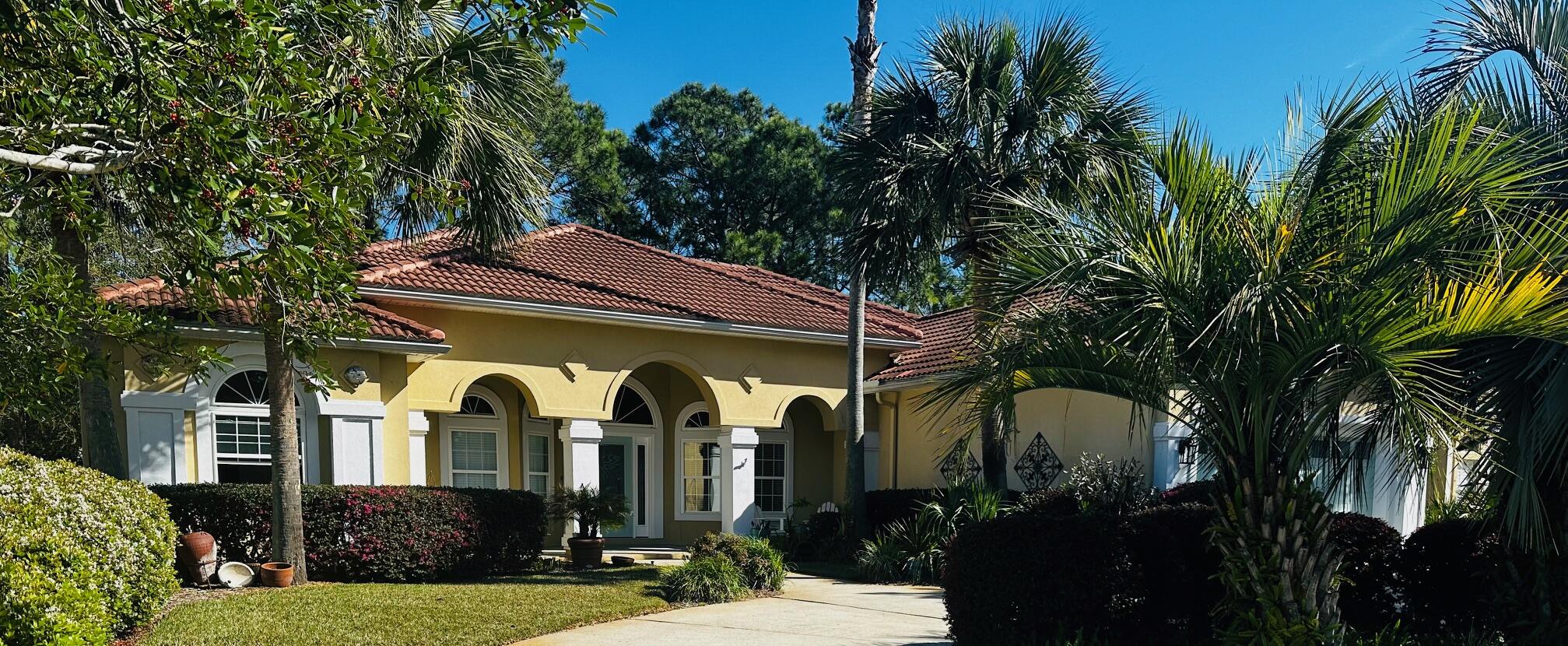 This immaculate and pristine home located on the 5th fairway of the renowned Emerald Bay Golf Course is an absolute MUST to see! As you enter the circle driveway of this Carib looking home with tons of character and lush landscaping, you will feel the warmth and amazing energy this home exuberates! As you approach the front door, you will love the large front porch and be mesmerized by all the beauty and privacy that surrounds you. Upon entering, the open foyer will lead you to an inspiring living room to welcome friends and family. This split floor plan features beautifully well-maintained pecan wood flooring, crown molding throughout, high ceilings and recessed lighting.