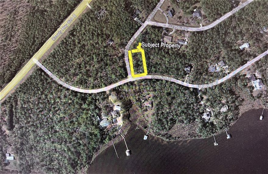 Large .56 acre level interior lot with mature trees and Bay views located in the neighborhood of Lagrange Shores is ready for your house plan.  Public roads with public water, public sewer and electric available.  Buyer will be responsible for paying tap fee.  Property is in an X Flood Zone.  Property is high and dry. Property is located 15 minutes to best beaches in Florida.   Buyer to verify all information.  NO HOA or build out time!!