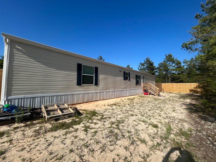 Now available for lease--18 Daffodil Circle! This brand new 2024 manufactured home offers 3 bedrooms, 2 bathrooms, and just under 1,200 square feet of thoughtfully designed living space. The split floor plan provides privacy, while the open-concept layout creates a warm and inviting atmosphere. Enjoy a spacious living area, a modern kitchen, a private primary suite with an en-suite bathroom, and a tucked-away utility room for added convenience. With energy-efficient features and stylish finishes throughout, this home is move-in ready and perfectly situated in a quiet, convenient location. Don't miss your chance to call this beautiful home yours--schedule your showing today!