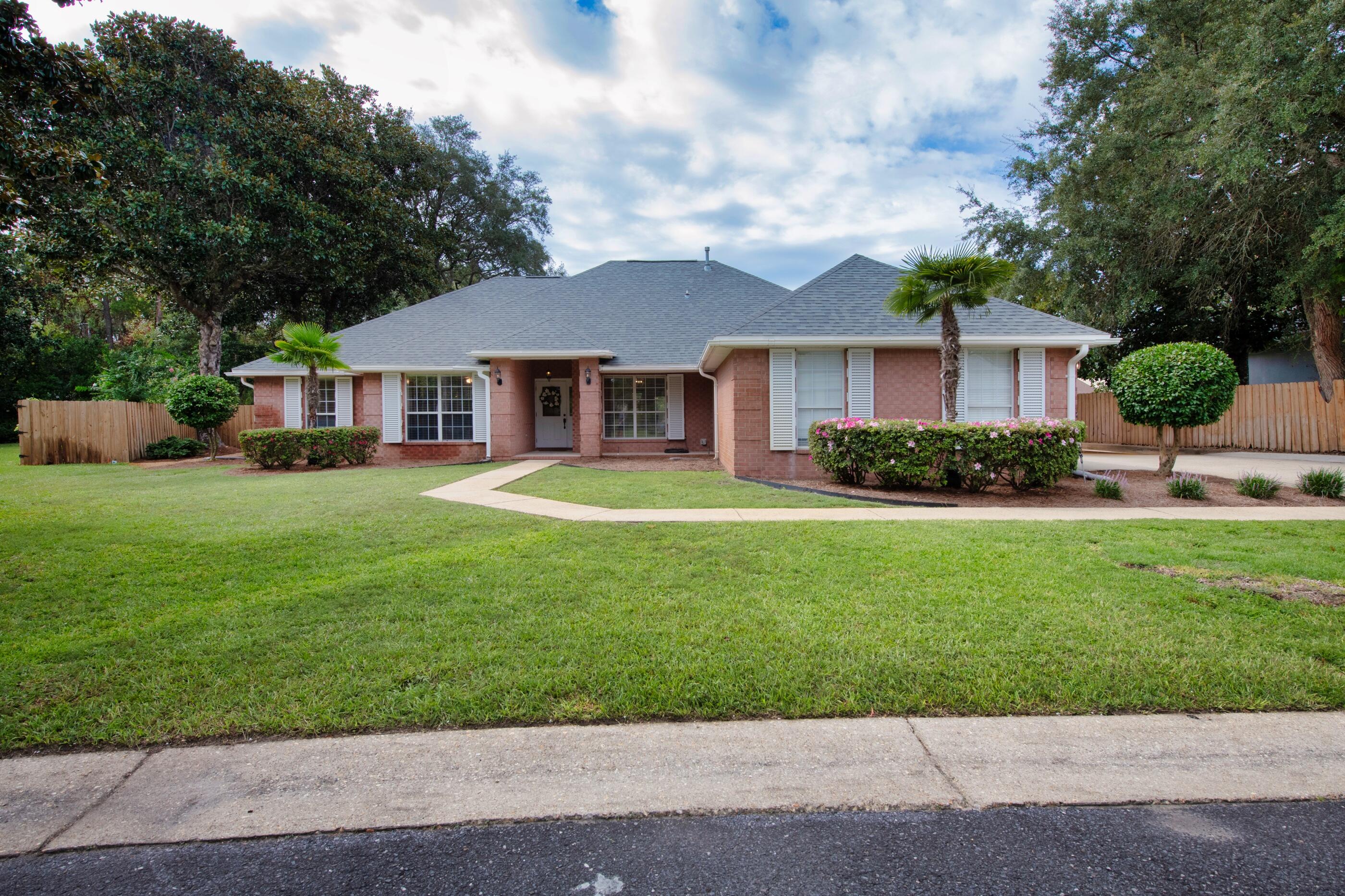 Welcome to this charming single-story pool home, tucked away in the gated community of Magnolia Plantation in Bluewater Bay. Situated on a quiet cul-de-sac, this 4-bedroom treasure is ready for you to make it your own! The property boasts lush landscaping, a spacious front and side yard, a large driveway for multiple vehicles, a saltwater pool with an expansive enclosure, and a 2-car side entry garage.Inside, you'll find an open floor plan featuring a formal dining room, a cozy living room with a gas fireplace, and a versatile flex space perfect for additional living space or a home office. The stunning kitchen is equipped with stainless steel appliances, including a gas range.