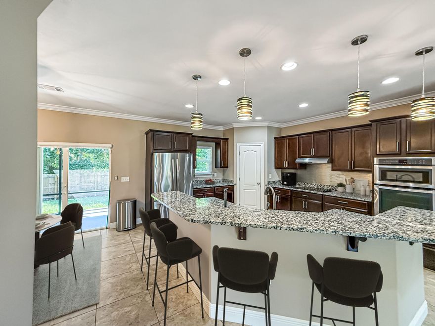 Affordable & Savvy Coastal Living with Community BEACH & boardwalk access!Welcome to this beautiful two-story home on the west end of Navarre, ideally located near hospitals, schools, shopping, and just minutes from the sugar-white beaches of the Gulf. With a designated traffic light to Highway 98, commuting east or westbound is convenient and stress-free.This thoughtfully designed home features four bedrooms and 2.5 bathrooms. The primary suite is on the first floor, offering comfort and privacy. For convenience, a half bath is located near the living room and kitchen, perfect for guests. Upstairs, you'll find three additional bedrooms, a spacious bonus loft/office area, and an oversized full bath featuring a private toilet area, double vanity, and tub/shower combo. The newly updated water heater is also located upstairs near the loft. From the upper windows, enjoy beautiful water views that make this home truly special.

The exterior is just as impressive with mature landscaping, full irrigation, and a double-car garage. The backyard is fully fenced, offering peace and privacy with a protected wooded area behind the home that will never be built on. Recent updates include brand-new fencing, a new front-day fence section, new garbage disposal, new stovetop, and freshly pressure-washed and fully repainted interiors and garagewalls and floor included. This home feels practically like new construction, thanks to meticulous care and attention to detail.

Community perks include private beach access just down the street, low insurance costs (under $2,300/year), low utilities, and the reliability of sewer and underground utilities. A Ring doorbell conveys with the home, along with the original alarm system (as-is).

Enjoy curvy neighborhood streets with beautiful architecture, low-maintenance living, and the unbeatable lifestyle of Navarre. This home is move-in ready and waiting for its next owner to love it as much as the current ones have.

Flexible closing date offered. Stay tuned for any open house dates for your convenience. Be sure to ask the agent for ALL documents that have been uploaded for this listing. 
