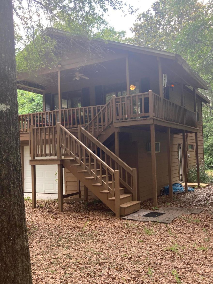 Multiple offers. Highest best due by 5pm Friday July 23rd ..Secluded cabin in the woods! This Cabin sits on 2.21 acres loaded with hardwood trees and close to  King's Lake. It is situated at the end of a cul-de-sac and is 2BR, 1BA, 640 Sq Ft. The main living area sits above a huge enclosed, climate-controlled garage area with a separate area for storage and where the washer and dryer are located. Large front covered porch for relaxing and listening to nature. Sliding glass doors open onto the wrap-around porches. Cabin is turn-key with all furnishings and household supplies. Riding lawn mower conveys with property. Property being sold as-is.This is an immaculate fully furnished cabin ready for your next getaway!