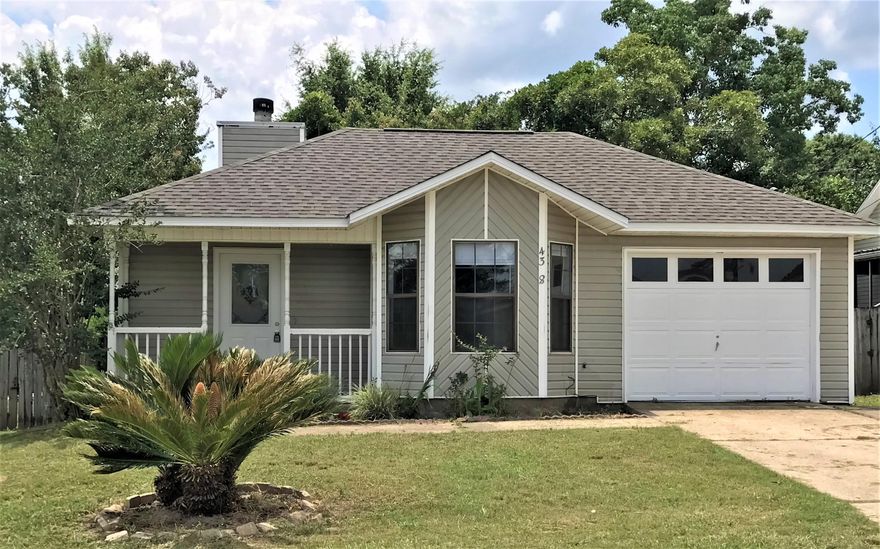 South of the Interstate (10).  Charming 3 bedroom 2 bath is a must see.  Newly painted. New LVP in living areas and all 3 bedrooms.  Wood burning fireplace looks so inviting when you walk into the living area.   The walk through Kitchen is located to the right The dining area in the front of the kitchen is surrounded by lovely bay windows.   Master suite comes with a very nice size walk-in closet.  Outside you will find a new deck for a leisure afternoon with the family or friends.