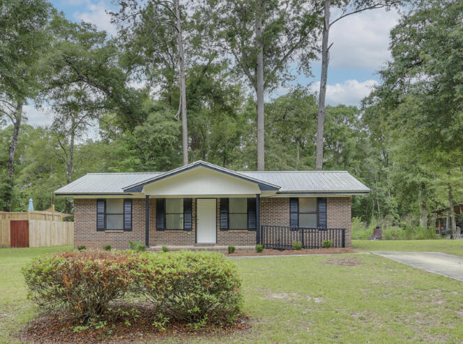 BACK ON MARKET -NO FAULT OF SELLERS!! This picturesque 3 bedroom, 2 bath is the perfect starter home or empty nester!! Beautifully updated with new paint, floors , light fixtures, doors and more-this one is turn key ready for immediate occupancy! Talk about low maintenance this little beauty is all brick with a 6yr old metal roof and no carpet! Perfectly located on 1/2 acre with plenty of room to add a pool!