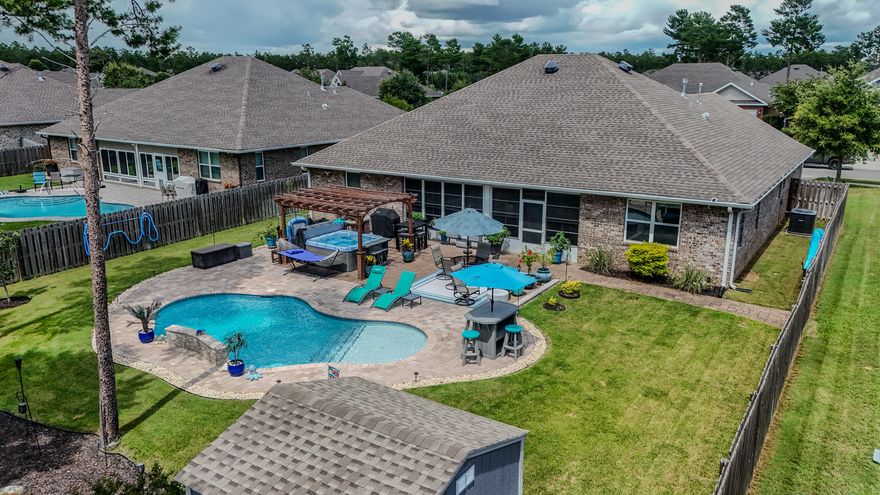 224 Sweet Tea Ln in Sweetwater at Hammock Bay is your Florida dream come true! This 3-bed, 3-bath home also includes a large flex room--that's perfect for a home office, media room, or guest overflow--your pick! With 2,514 sq ft, a 3-car garage, and a 10x28 enclosed Florida sunroom (with its own A/C, bug/pollen/rain-blocking windows, and epoxy floors by Ninja Flooring), there's room to spread out and stay cool. Step out back into your private paradise--fully fenced with a sparkling ozone pool, hot tub, paver patio, and storage shed, all backing up to peaceful natural green space.  Granite countertops in kitchen and baths, updated lighting, spacious layout, upgraded luxury vinyl flooring, and a VA assumable loan at 2.75%--now that's worth sipping sweet tea over! Hammock Bay is a premier master-planned community in Freeport, Florida, offering resort-style living across 3,000 acres of beautifully preserved woodlands and green space. Residents enjoy an impressive array of amenities, including a 6,000 square foot Lake Club with a caterer's kitchen, library, kids' room, and outdoor firepit overlooking Anchor Lake. The luxury fitness center is fully equipped with cardio and weight machines, locker rooms, and flat-screen TVs. Outdoor recreation is second to none with two resort-style zero-entry pools, a competition lap pool, children's splash pad, lighted tennis and pickleball courts, basketball courts, a putting green, and one of the largest playgrounds in the region. Hammock Bay also features a 60-acre sports complex with fields, a disc golf course, shuffleboard, splash pad, and miles of nature trails. The community's extensive green space includes over 12 miles of sidewalks and trails perfect for walking, running, and biking. Residents have exclusive access to Steamboat Landing, a bayfront clubhouse with 480 feet of shoreline and a private dock for fishing, paddleboarding, and kayaking. The Town Center brings charm and convenience with a general store, brewery, food truck court, and a massive outdoor LED screen for community events. Pet owners love the fully fenced Canine Commons dog parks, complete with washing stations and water fountains. Hammock Bay also offers an on-site school, Freeport Middle School, and is zoned for highly rated elementary and high schools nearby. With fiber-optic internet, gated neighborhoods, on-site HOA and security, and a full calendar of community eventsfrom farmers markets and movie nights to seasonal festivals and live musicHammock Bay delivers an exceptional lifestyle for all ages.