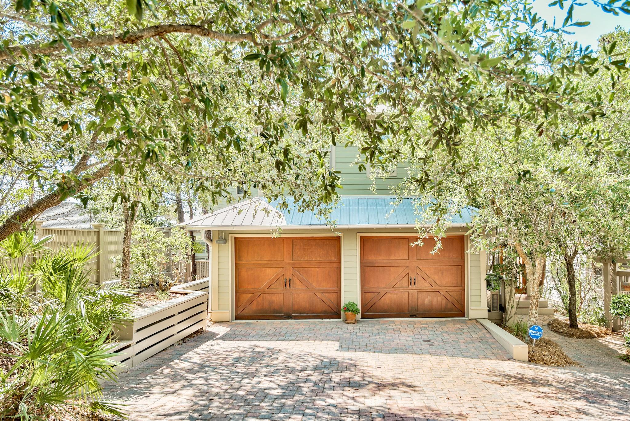 Fantastic opportunity to own your private oasis, -1/2 mile from the beach! Summer Ridge, a small gated community nestled among native vegetation and mature oaks, is located in close proximity to shops, restaurants and Santa Rosa Golf and Beach Club. This home features a master suite on the first floor and two additional bedrooms and two full baths on the second. Each bedroom on the second floor also has a deck. The kitchen features Quartz counters and stainless steel appliances. The home is accented with beautiful wood floors. A stone fireplace makes the living area feel warm and inviting. The cathedral ceiling is accented with aged cypress and ample windows ensure that the area is filled with light. Outside Fireplace and garden with fountain