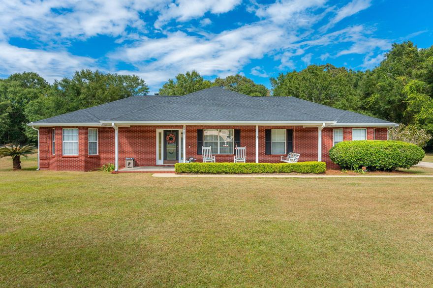 Beautiful 4 bedroom 2 bath home on 2 acres in south Baker providing a easy commute to the local bases, beaches, and shopping centers. Step into the spacious living room with wood burning fireplace  just in time to stay cozy for the upcoming holidays. Kitchen boasts plenty of counter cabinet space to meet all your cooking needs. Beautiful engineered hardwood floors in the living room and tile in the wet areas. Enjoy your morning coffee on the enclosed back porch while watching the kids and family dog play in the massive fenced in backyard.  Roof 2020 and water heater was replaced within the last 5 years.