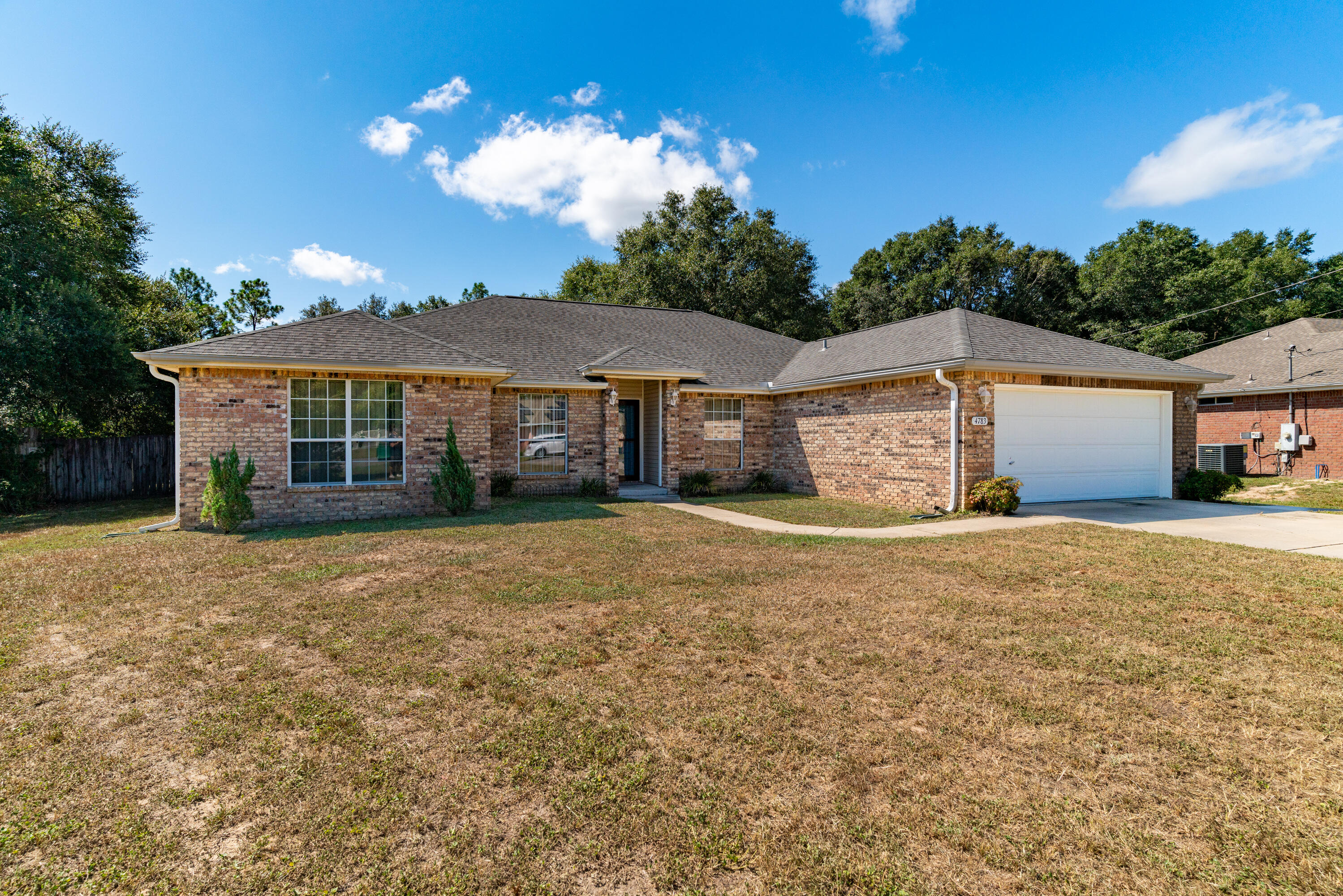 ASSUMABLE 5% MORTGAGE AVAILABLE Large 4 bedroom - 2 bathroom, all brick home on LARGE 0.56 acre lot and pay county taxes! NEW ROOF & NEW AC in 2017. This large split floor plan offers a formal dining room, office/flex room, spacious living room with wood burning fire place, huge kitchen with island, breakfast bar, & pantry, dining area (off kitchen), indoor laundry room, and a two car garage with auto opener. The large master bedroom offers plenty of room and bright light. The master bathroom has a double vanity, garden tub, separate shower, and dual walk-in closets. The 3 additional bedrooms & another full bathroom. The sliding glass door leads you the enormous back yard with mature trees and a large detached 13x18 workshop.