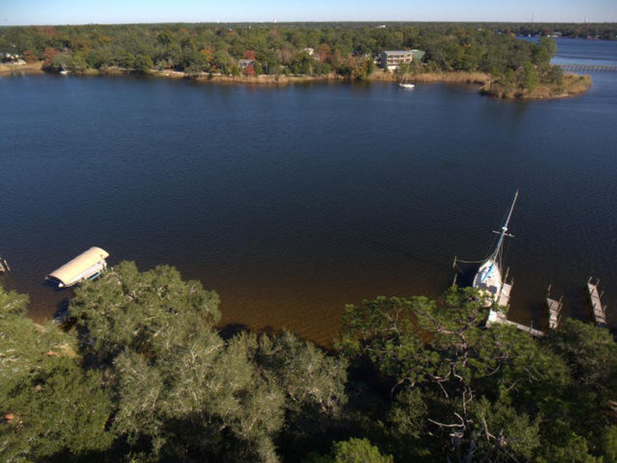 This listing offers 2 parcels. ( 292 and 293 S Bayshore drive) Beautiful, secluded setting on Tom's Bayou. This property is a great set up with a lot on the water that is apx. 75x75 and a lot high and dry building site across the road that is 75x150. You can build your new home up high with a great view and place your dock, decking and boat lift right out your front door on the water. These properties are becoming hard to find and this property is well worth a closer look before it is sold. There are nice homes in the immediate area and the location is only a few minutes to the bases, beaches and shopping. The property is treed and natural at this time, awaiting your floor plans. This would also make for a great investment property to hold on to.