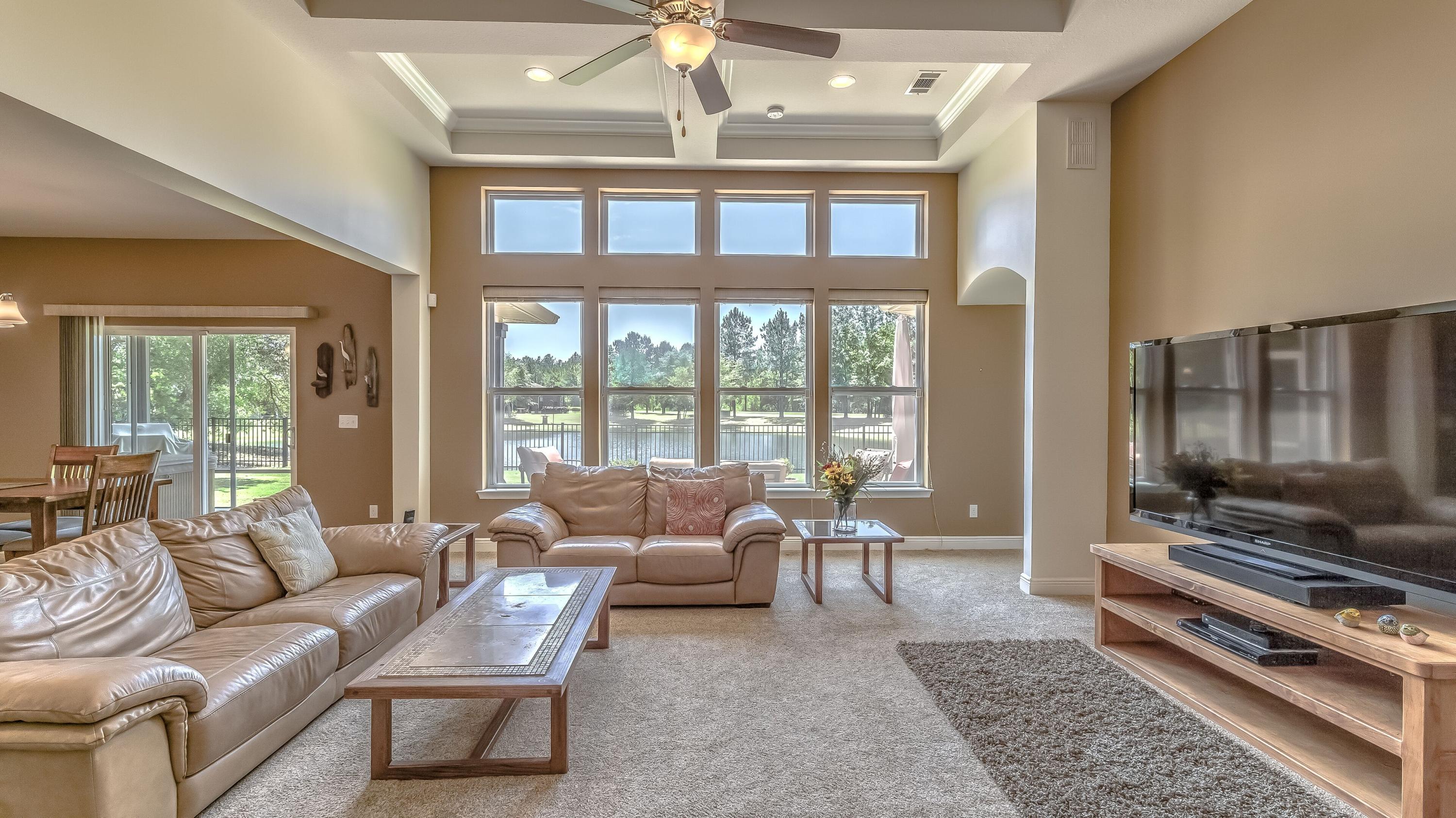 Great waterfront views from all rooms in back of home, including Master Retreat, the Huge Living Room, Kitchen and the back bedroom. A peaceful setting in a quiet neighborhood of only 27 homes in Bay Cove at Hammock Bay. In addition to four bedrooms, there is an office/music room with glass French Doors. Up-graded carpet/pad and freshly painted walls. There is a Rinnai tankless water heater and Generic home generator, luxury gourmet kitchen with a vented gas cook top. The front loading washer/dryer units convey with the sale, plus Hot Tub in the titled screen porch remains. PLEASE NOTE there is a floor plan of this model in the pictures section. Actual home is a mirror imagine of the floor plan.