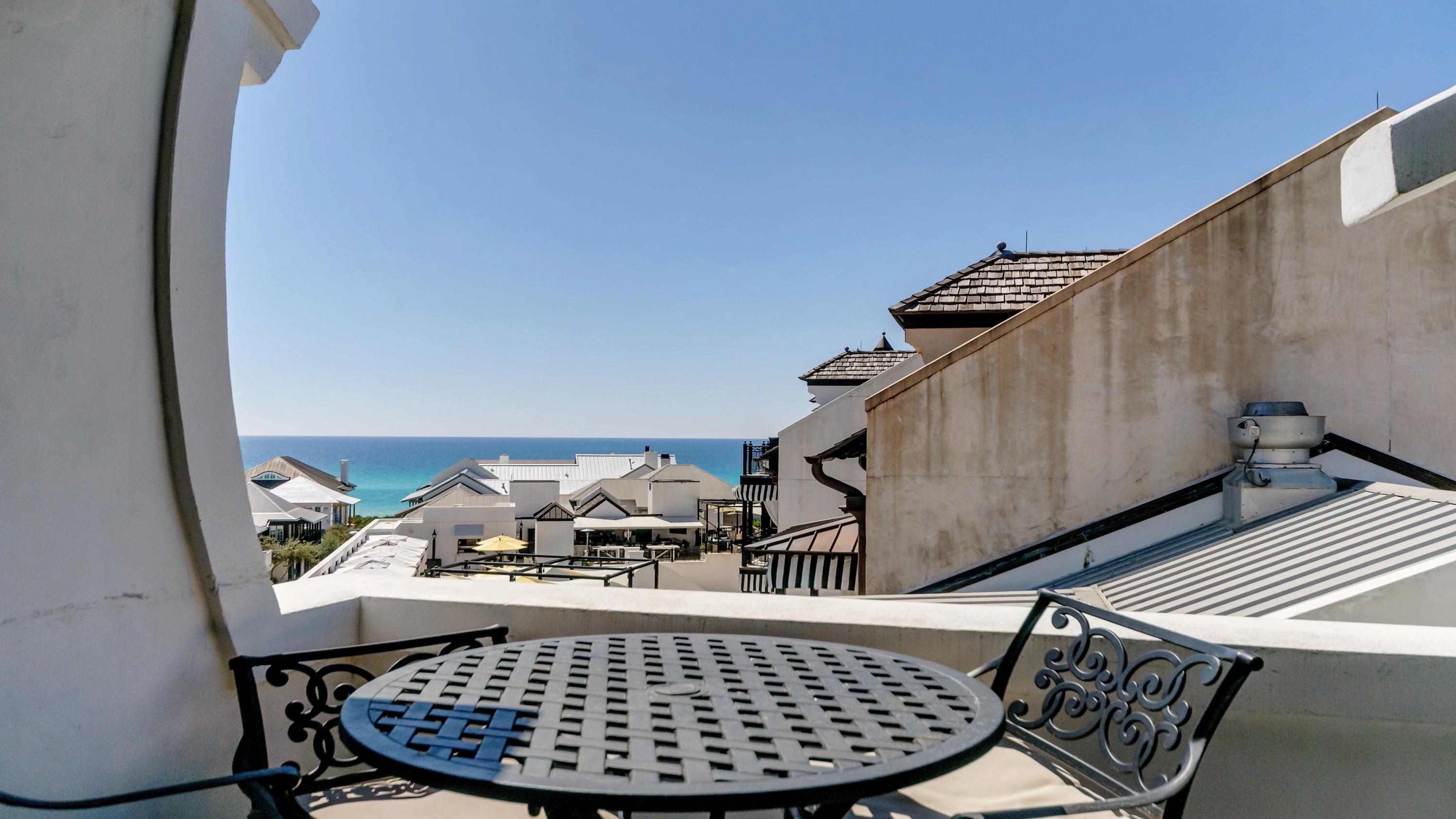 This private corner condo is your gateway to everything vibrant Rosemary Beach has to offer. The 3 bedroom, 2.5 bath penthouse condo features 5 balconies including a covered loggia for entertaining with views of both Main Street AND the Gulf of Mexico. Recently renovated, the 2nd floor is a stylish, open living area with a wall of windows to flood the space with natural light. The stunning kitchen has been updated with open shelving, a waterfall quartzite island and Viking appliances. A balcony off the kitchen is the perfect place for dining al fresco while looking at the Gulf or relaxing on the swinging daybed. This home is a reverse floor plan with a huge master bedroom and sitting area, ensuite bath with separate garden tub and shower and private balcony overlooking town center.