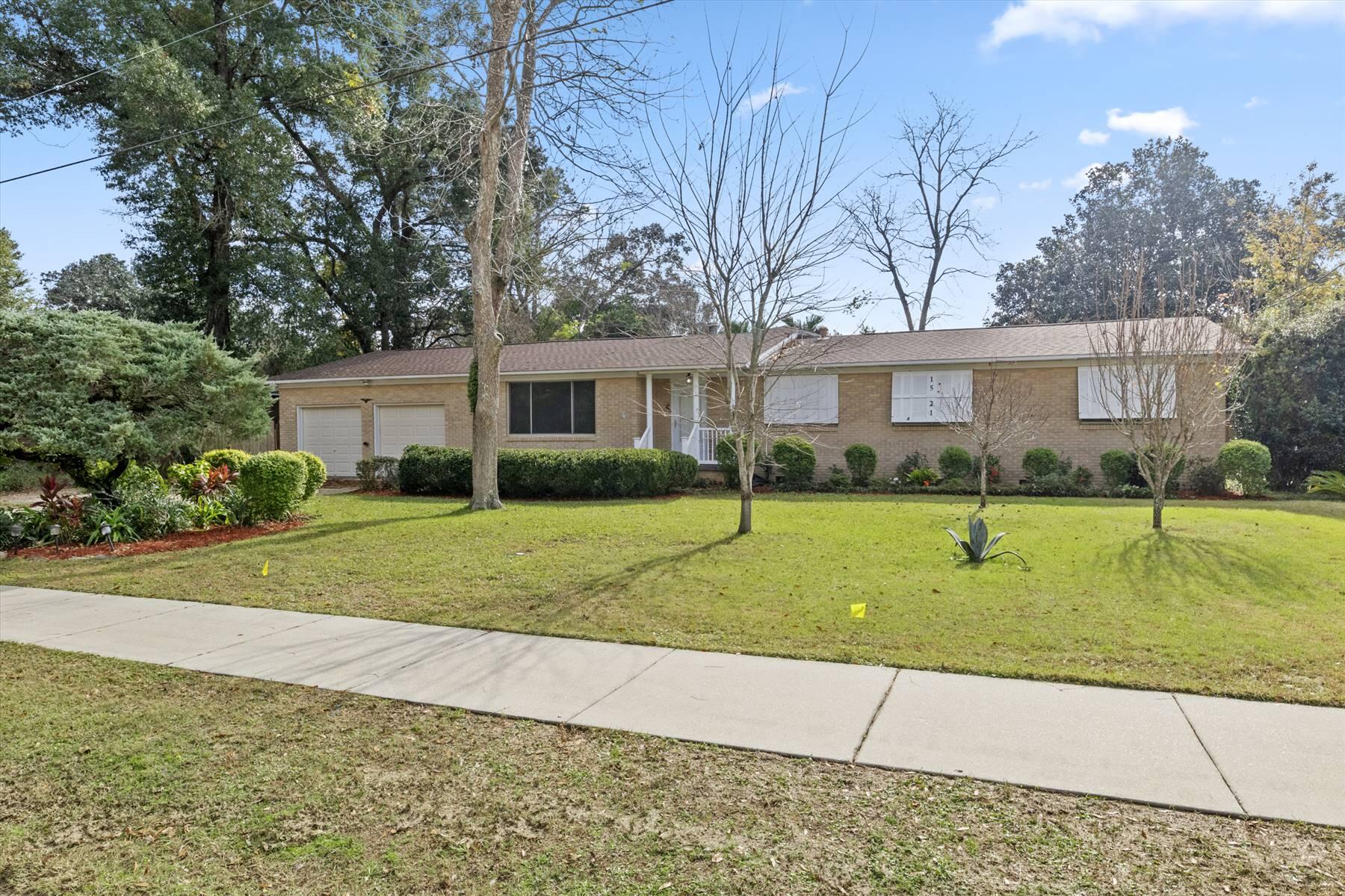 This spacious 4-bedroom, 3-full bath home offers over 2200 sq. feet of living space, seamlessly blending classic charm with modern comfort. Located on a large lot with beautiful palm trees, the expansive 1/3 acre yard provides plenty of room for outdoor activities. The attached 2-car garage includes one converted space turned into a convenient workspace. Inside, you'll find a bright living room and a spacious great room with an en-suite, handicapped-accessible bathroom which is accessed by handicap ramp to the great room. The kitchen features real wood cabinetry and ample space for a large eat-in dining area with an additional dining room for holiday meals. The master suite boasts a private bathroom, while the three additional bedrooms offer flexibility for guests, a home office, or more.

Significant upgrades in 2017 include hurricane-resistant features for added peace of mind: steel panel shutters, a new entry door, upgraded skylights, a reinforced garage door, and hurricane clips with a new roof. Recent updates also include new flooring in the kitchen and family room, along with fresh interior paint. One or more photos have been virtually staged. This home offers both practicality and ample space inside and out. This property is being sold AS IS.