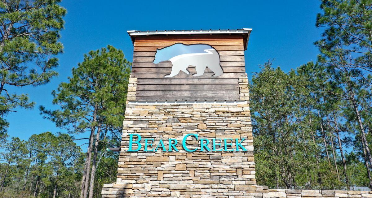 Spectacular lot in the gated Bear Creek subdivision, the perfect place to build your new primary or second home. Ideally located just 15 minutes from the beach, this approximately 100' x 145' corner lot affords ample room to build a spacious home plus a private pool if desired. Bear Creek features a variety of amenities for owners' of every generation to enjoy including a community pool and playground, as well as tennis, basketball, and pickleball courts and is less than 15 minutes to area golf courses.