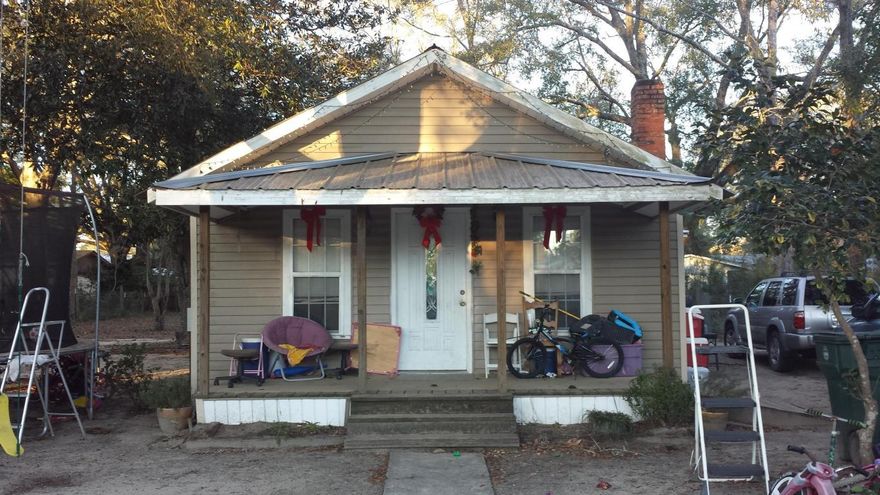 This little home is located in the middle of town, has a fenced in back yard, and a few large oak trees. The home needs a little TLC but wouldn't take much to make it your own! It has a metal roof and vinyl siding. Does not have central heat and air. For this price you could easily add on to the home and have a nice little place inside the city limits. All measurements and dimensions are approximate and must be verified at buyer's expense. Property to be sold ''As-Is'' with no warranties or repairs.