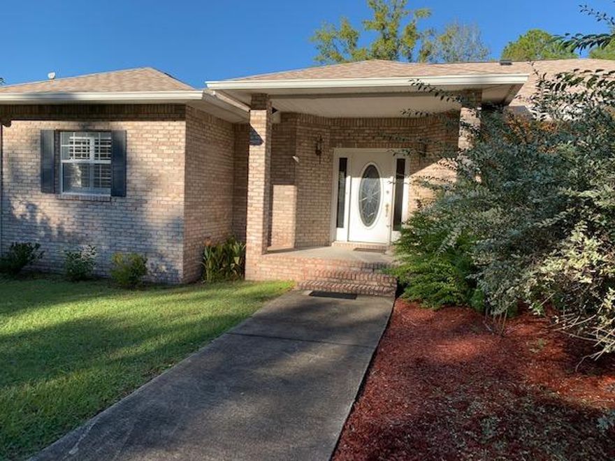 Beautiful, spacious waterfront home on 3/4 acre w/large trees and wonderful views. This conveniently located brick home features an open, split floor plan w/ 3 bdrs, 3 baths, dining, living, breakfast nook and breakfast bar. Laminate hardwood throughout -no carpet! Kitchen features stainless appliances and granite counters. Plantation shutters are throughout along w/many other nice upgrades. Sliding glass doors lead out to the large screened in porch and an additional open deck w/outdoor shower. Side entry garage and outdoor storage building. Home has a brand new roof, is in excellent shape and ready for occupancy.