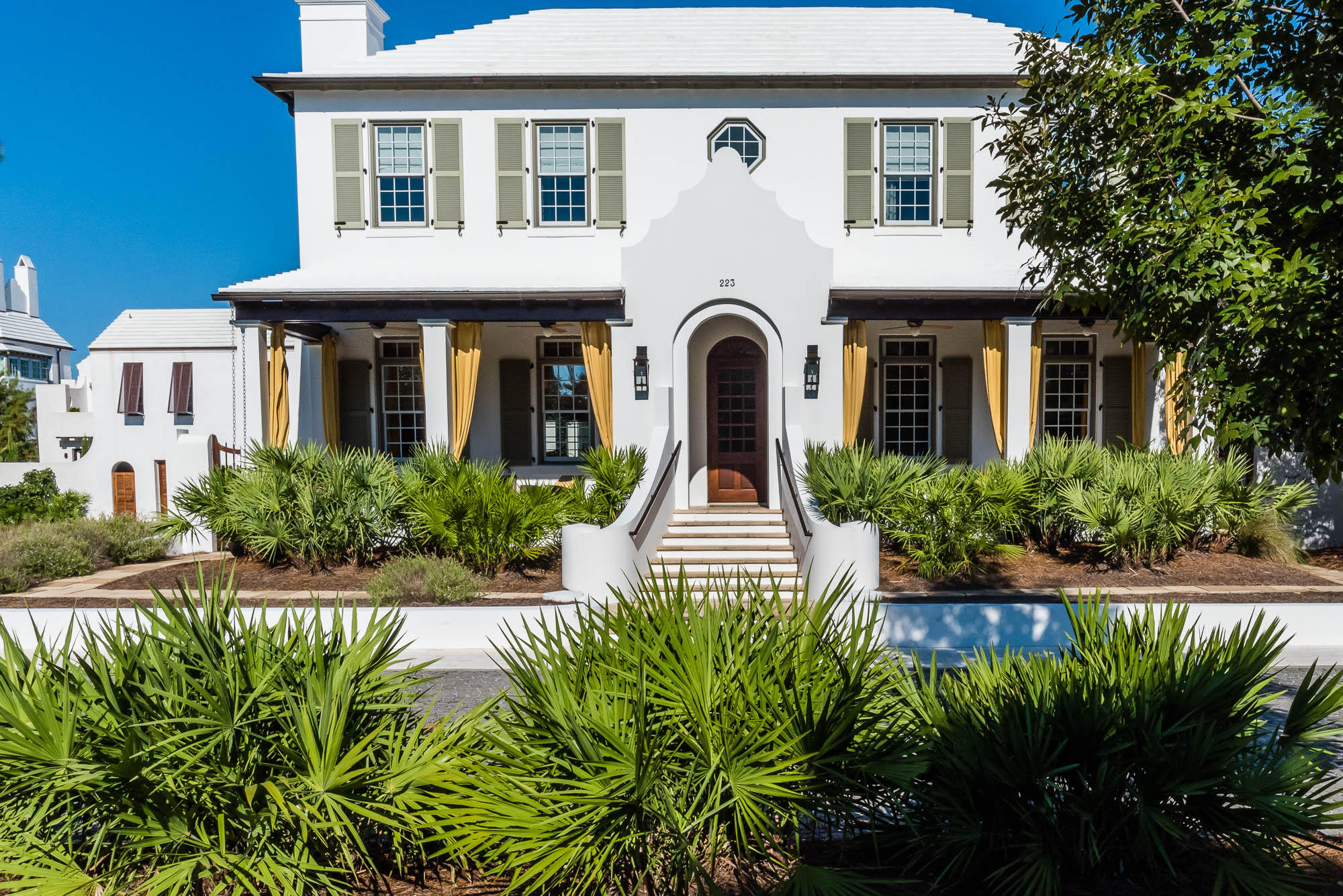 One of the most revered villas in Alys Beach is perched on a unique, generous-sized homesite overlooking the serene greenspaces of Central Park and the Nature Preserve. The award-winning Caliza Pool and Restaurant are just steps from your front veranda. Surround yourself in the ambiance of easy living and nature as you relax on the inviting breeze-filled front porch. The entry of this home offers both light and drama with an exquisite Australian cypress stairway. The family centric living room is accented with a magnificent fireplace and built in cabinetry. The flowing first level floor plan opens to the separate dining room leading to the spacious well-appointed kitchen.