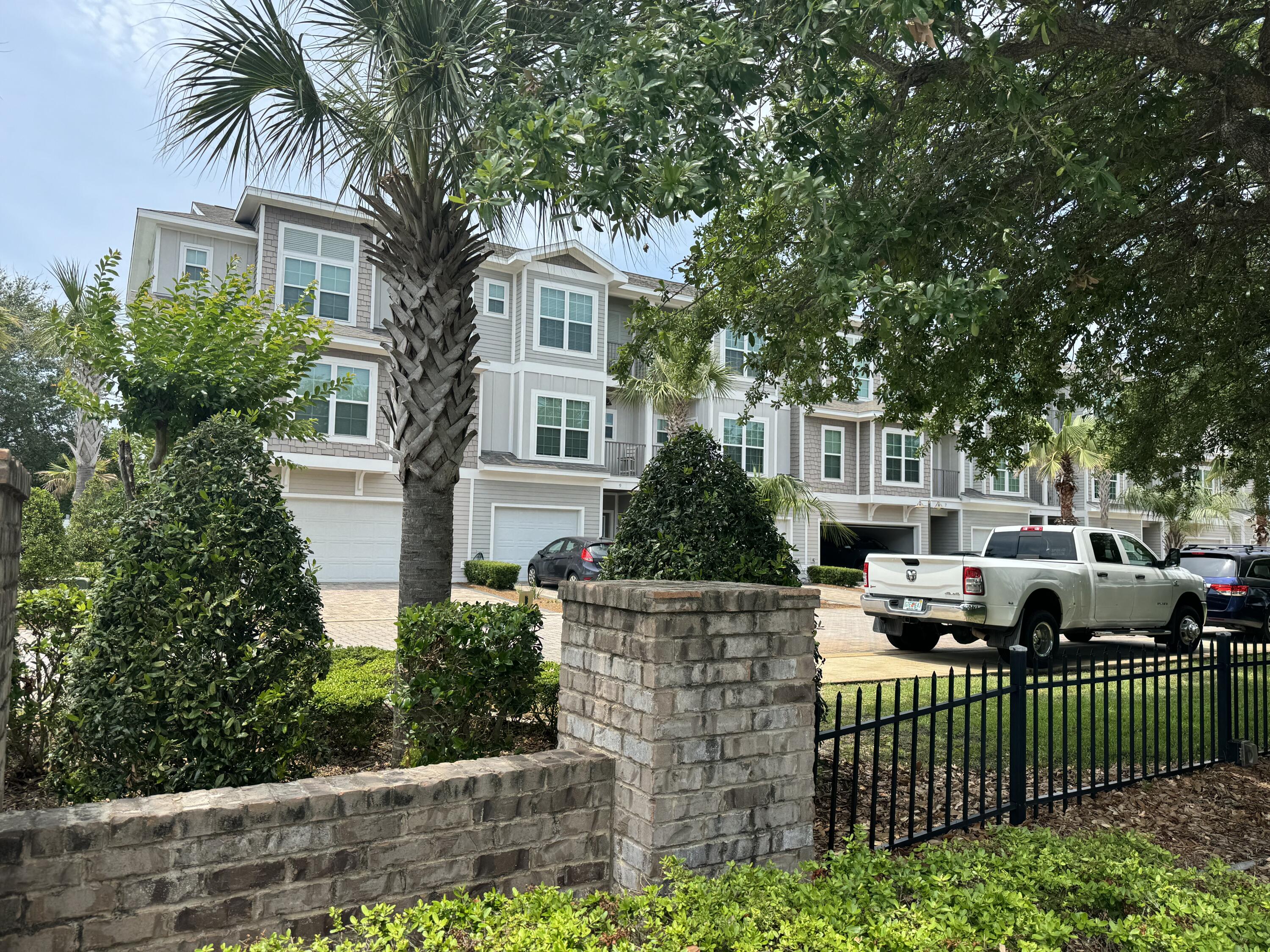 INVESTMENT OPPORTUNITY!! This 4 bedroom, 4 bathroom FORMER MODEL home comes FULLY FURNISHED! This gorgeous home has options of being a vacation rental, 2nd home or full-time residence. It was professionally decorated by Tuskers Home Store. 2025 reservations are already on the books! It is located in a quaint community of only 20 residences known as Driftwood Drive Townhomes. It is footsteps from the sugar white sand beaches, public beach access w/restrooms and shower, world class fishing, and local dining. This property is modern, energy efficient, and has luxurious appointments. Built in 2017 as an 'earth cents' energy efficient home it has cement board siding, impact glass, insulated garage door, tiled garage floor, and 50 gallon hot water tank with dehumidifier pump built in. There is porcelain tile, beautiful oak hardwood floors, and crown molding throughout. The first floor has a spacious bedroom with two custom built-in bunk beds, a full bath & a full size stackable washer and dryer. The second floor features a large kitchen with granite countertops, Frigidaire Gallery stainless steel appliances, and a large maplewood island perfect for entertaining a crowd. There is also a large bedroom and full bathroom located conveniently off the kitchen. On the third floor, you will find the master bedroom with the gorgeous ensuite bath; a luxurious oversized shower & soaking tub as well as another bedroom with a private bath and a second washer and dryer hookup. Outside, you'll find the backyard is perfect an evening BBQ. There is a community pool complete with a surrounding sun deck area and restrooms. This is an opportunity to own that beach house you have been dreaming of! This property comes fully-furnished, rental ready and is thoughtfully designed to welcome all your guests. Make wonderful family memories or a great investment!