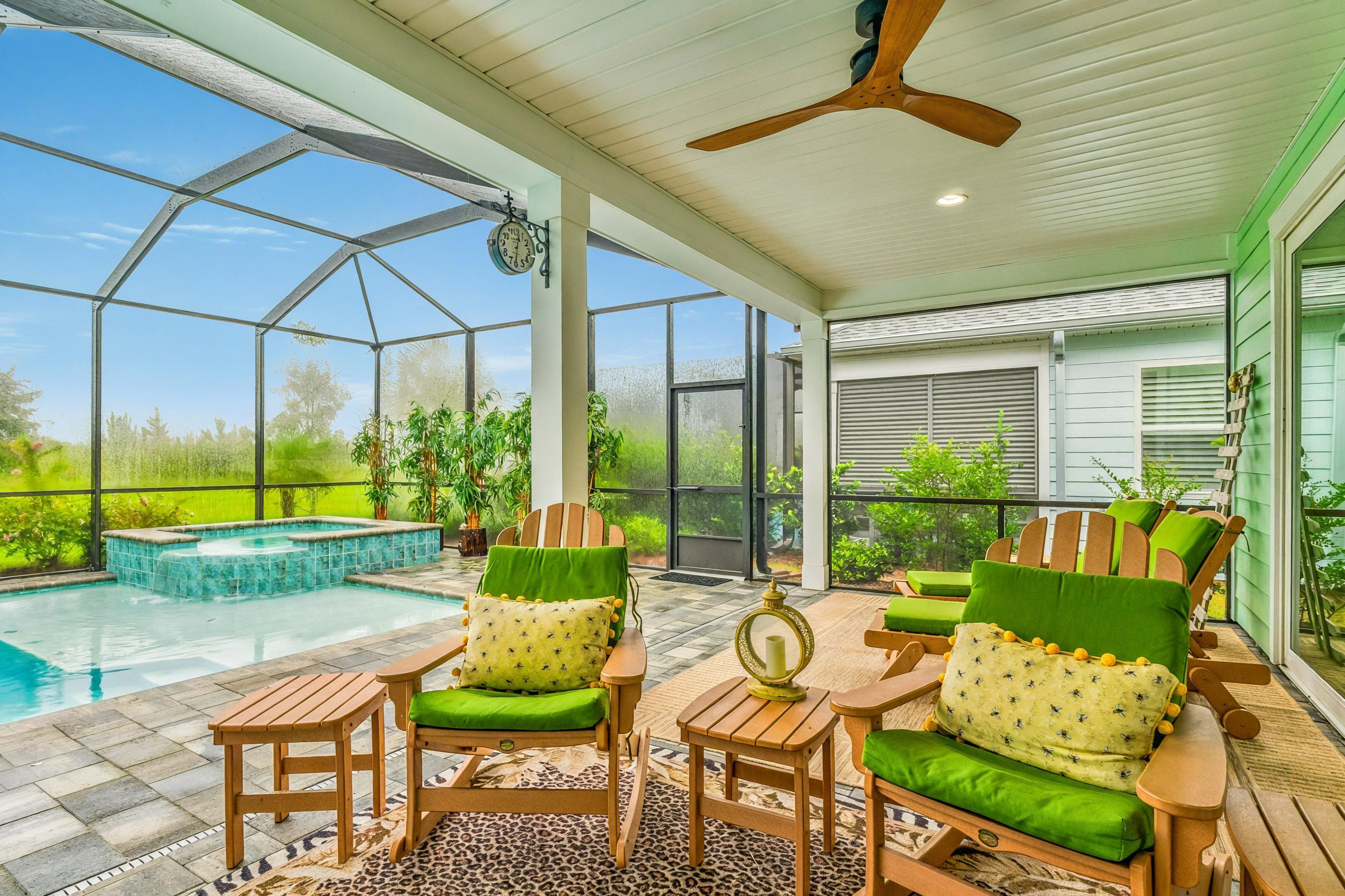 Assumable loan at 2.75% with 521k balance remaining! Welcome to 8412 Margarita Place, a pristine, like new pool home in the 55+ community of Latitude Margaritaville Watersound. This beautifully customized 3-bedroom, 3-bathroom Breeze Bay floor plan offers the perfect blend of luxury, functionality, and relaxed coastal living, all on a quiet cul-de-sac with no drive by traffic. Thoughtfully designed for both everyday comfort and entertaining, the home boasts an open, single-level layout with soaring 9' ceilings, 8' interior doors, and luxury finishes throughout. The heart of the home is the expansive quartz kitchen island, comfortably seating six and opening into a light-filled great room with vaulted ceilings, custom fireplace, and a wall of glass sliders that extend your living space to the fully screened lanai. Outside, enjoy your own private retreat featuring a custom pool with a hot tub, an extended tanning ledge, and elegant pavers, all overlooking the tranquil pond beyond. The primary suite is a peaceful haven with recessed ceilings, bay windows with water views, private pool access, and two spacious walk-in closets. The en-suite bathroom features double vanities and a large, tiled walk-in shower. Two generous guest suites each enjoy their own full bathrooms, ideal for visiting family or friends. Additional upgrades include Revwood Mohawk laminate flooring, premium tile selections, upgraded lighting and plumbing fixtures, recessed lighting, ceiling fans, quartz countertops throughout, security system with cameras, premium blinds, and more. This home has been meticulously cared for, lightly lived in, and fully inspected in 2024 with all warranty items addressed. Furniture is negotiable, including Polywood deck furniture, new beds, stylish living pieces, and more. The home also includes a 2-car garage and HOA-maintained landscaping, giving you more time to enjoy the community's resort-style amenities. Latitude Margaritaville Watersound is an exclusive gated community just 7 miles from the beach and less than 10 minutes from ECP Airport. Residents enjoy access to an on site restaurant, resort pool, pickleball and tennis courts, fitness center with lap pool and spa, music venues, clubs, and a vibrant social calendar. New amenities coming soon include a marina, shopping and dining village, theater, ceramics studio, workshop, and more. Just 3 miles from the new Tallahassee Memorial Healthcare campus and FSU College of Medicine extension. Don't miss this rare opportunity to own a like new, fully upgraded home with an assumable loan at 2.75% in one of the area's most exciting communities.