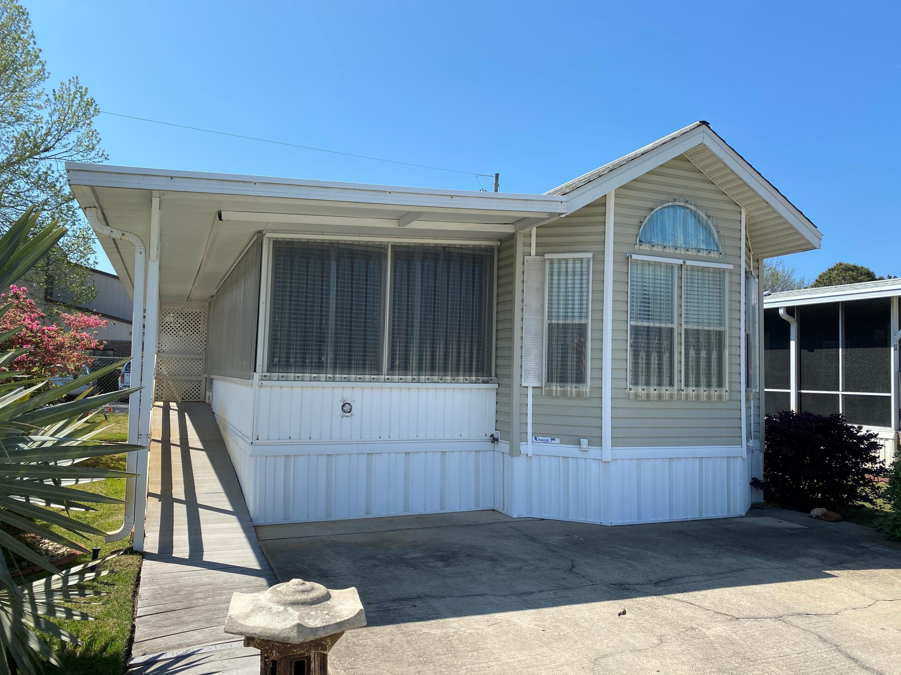 Located just 2 blocks to the beach, Fox Run is a Gated RV type Community. This Cozy 2BR/1BA manufactured home features large covered porch, new A/C with 10 yr warranty, hurricane shutters, white appliances, BBQ grill and storage shed. This is a Perfect opportunity for a vacation home or retirement home. Centrally located, Fox Run #12 is close to Shopping and Entertainment and is just a short walk to the sugary white sands of the Gulf Coast. See You at the Beach!