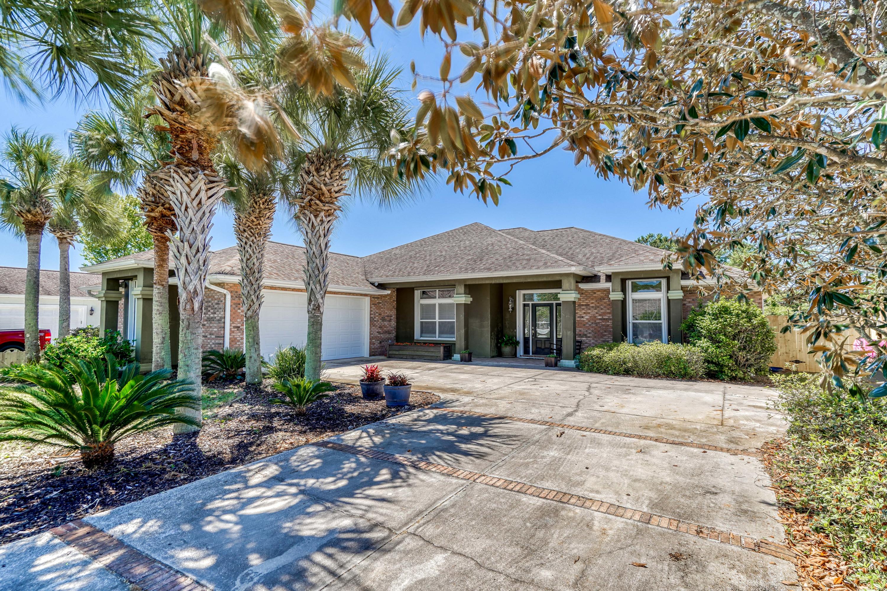 Situated on a quiet street just a short stroll from the emerald green waters of the Gulf of Mexico is a spacious getaway you will look forward to coming home to. Upon arrival you will notice the lush landscaping and abundance of parking. Formerly built as a builders personal home, and used during the Parade of Homes, no detail has been overlooked. Once inside you will be pleased with the spacious great room featuring a double trey ceiling with crown molding, gas fireplace with built in bookcases and large windows overlooking the pool and hot tub located out back. The kitchen is a chef's dream featuring granite countertops, tons of cabinetry with slide out drawers for easy access, a center island, stainless appliances, double oven's, a secondary vegetable sink with disposal and so much more Entertain friends & family utilizing the formal dining area, or enjoy a quick snack at the kitchen island, or the eat in kitchen. A split bedroom design with three bedrooms and three full baths includes duel master suites, one located on each side of the home, both with access to the patio and pool deck. The primary master suite includes a huge California Closet with racks for long hanging and short hang, built in shelving, a center island, and shoe rack. A private oasis awaits you out back, with a spacious covered patio perfect for outdoor dining, a heated salt water pool & hot tub, additional lush landscaping all with irrigation from a well, but minimal grass for easy up keep. Also included out back is a large building which has been split into two spaces; one side features a 300 sqft bonus room which could function as a guest suite, fitness space, or game room. The opposite side has been outfitted as a workshop and includes a garage door for getting equipment in and out easily. Make the most of your time lounging by the pool, or take a quick walk to the beach, either way you will love where you live. Less than 5 minutes from shopping, dining, and so much more!